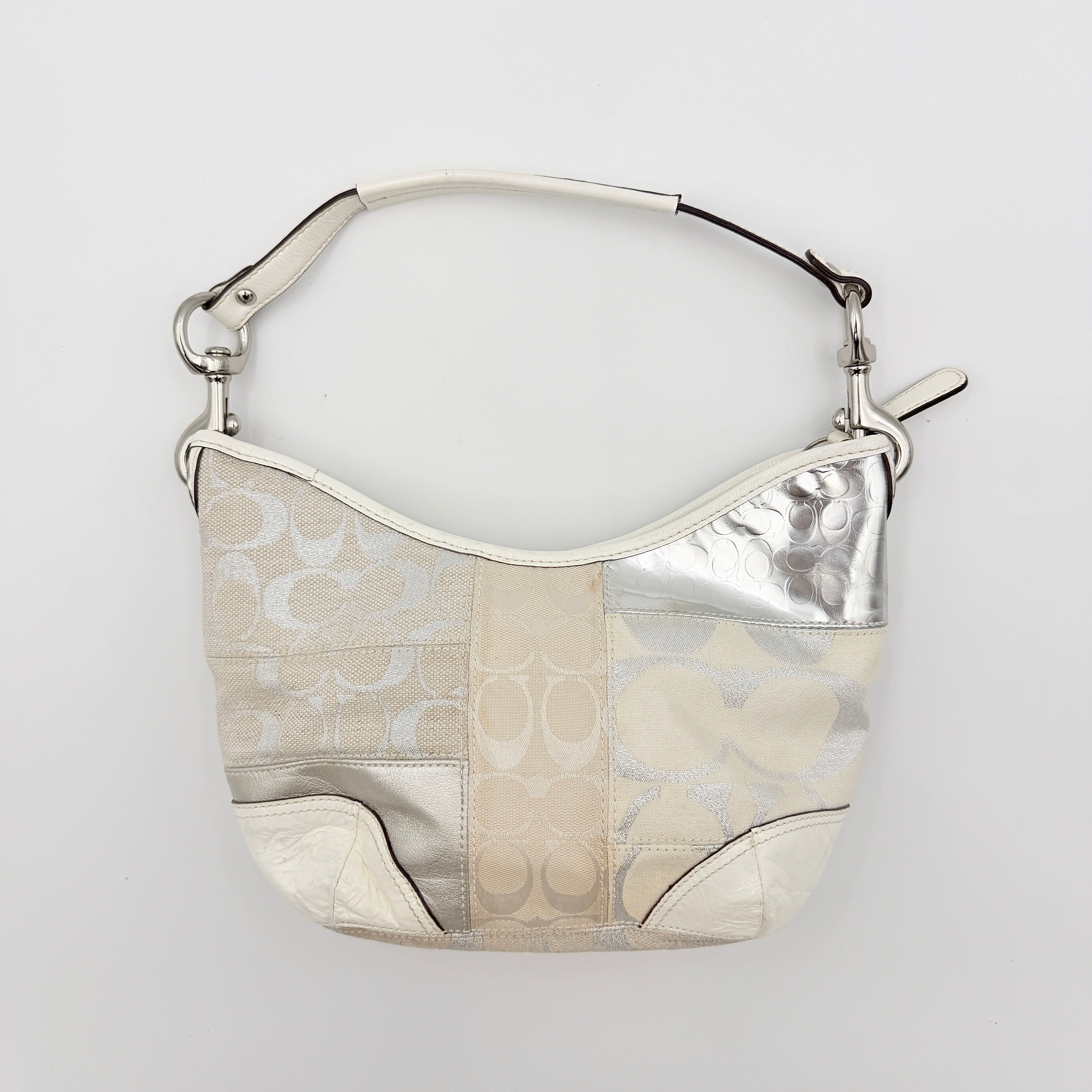 Coach Y2K Signature Patchwork Hobo Shoulder Bag in cream and silver jacquard with wide leather handle, shown on a white background.