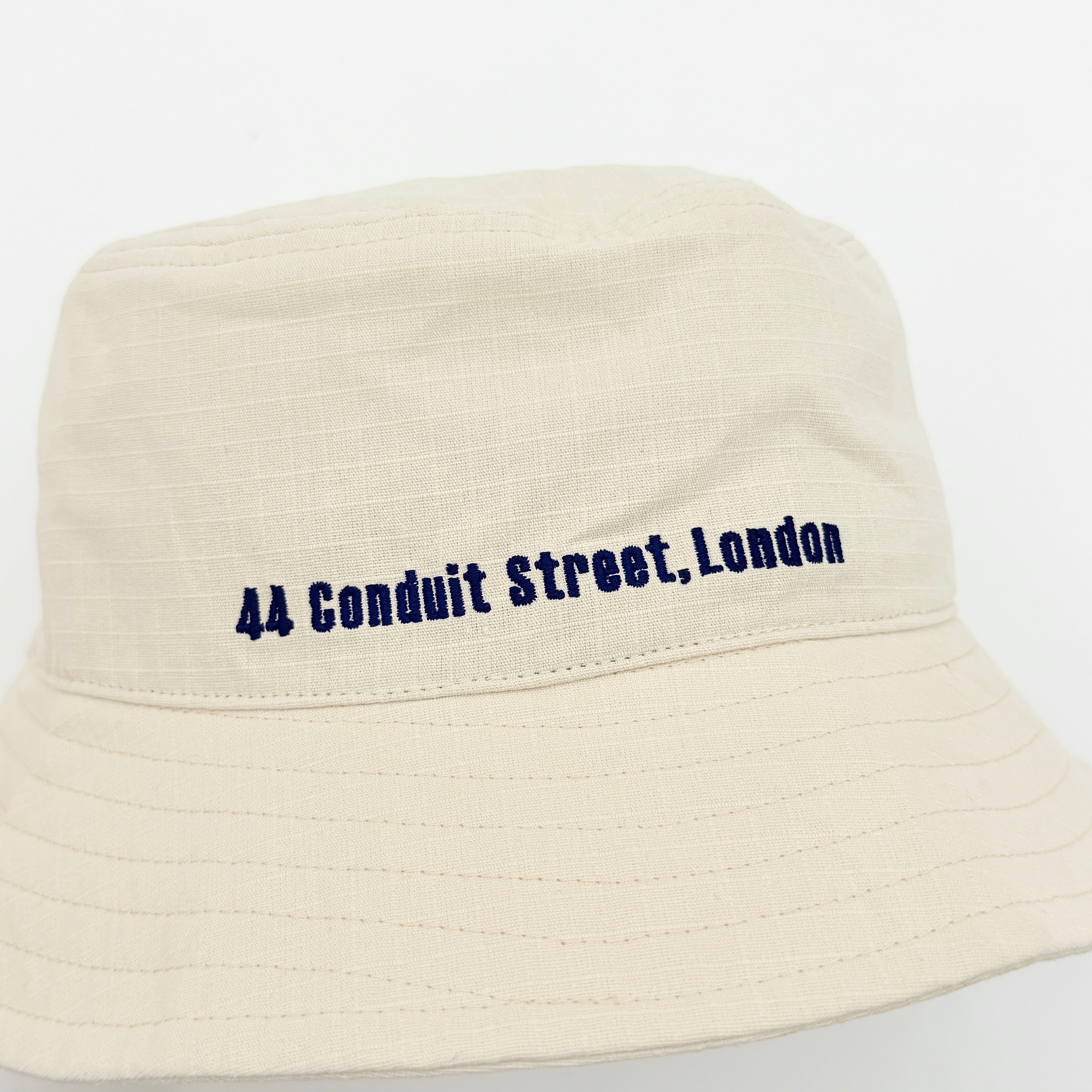 Vivienne Westwood Orb London bucket hat in cream cotton with black embroidery, shown from the front.