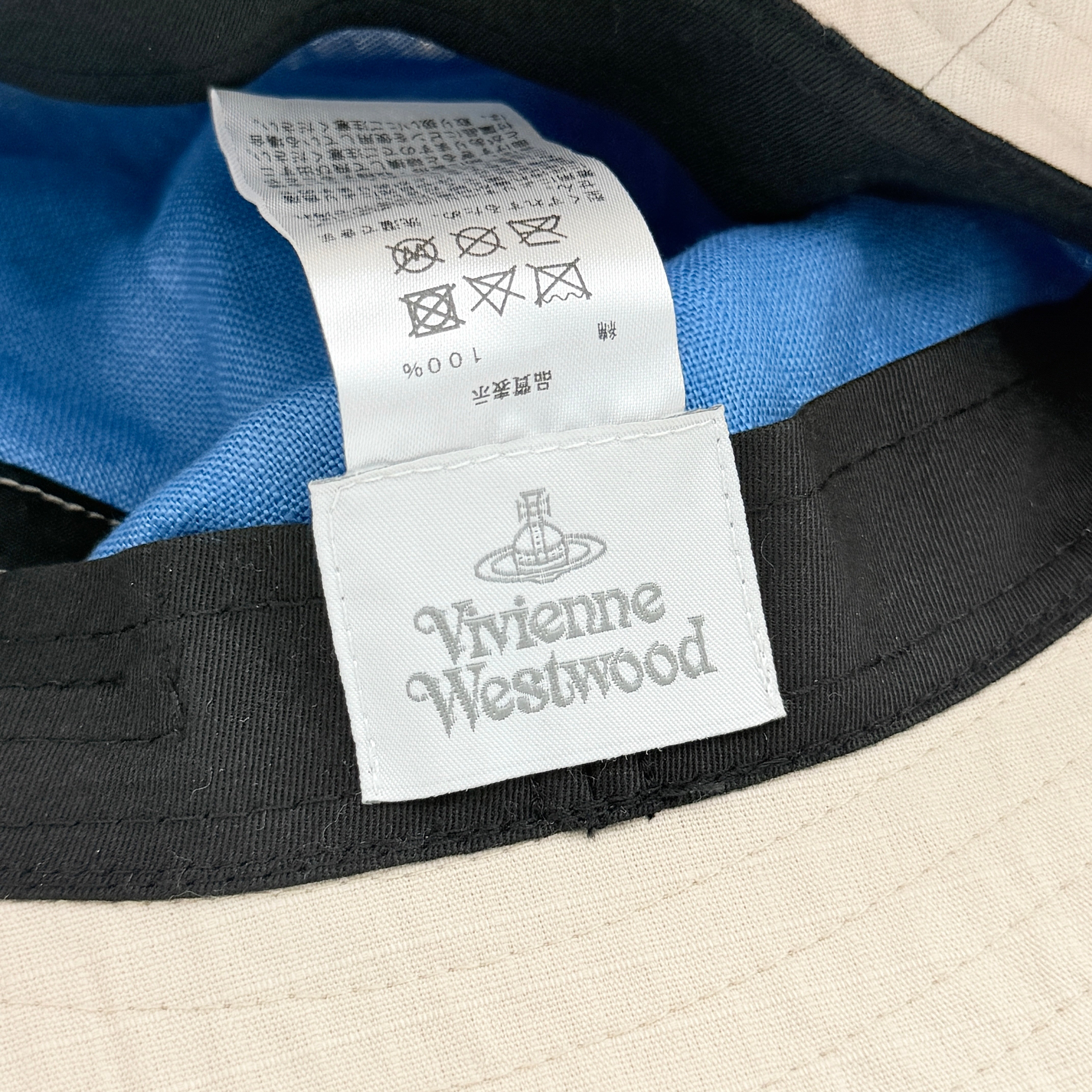 Vivienne Westwood Orb London bucket hat in cream cotton with black embroidery, shown from the front.