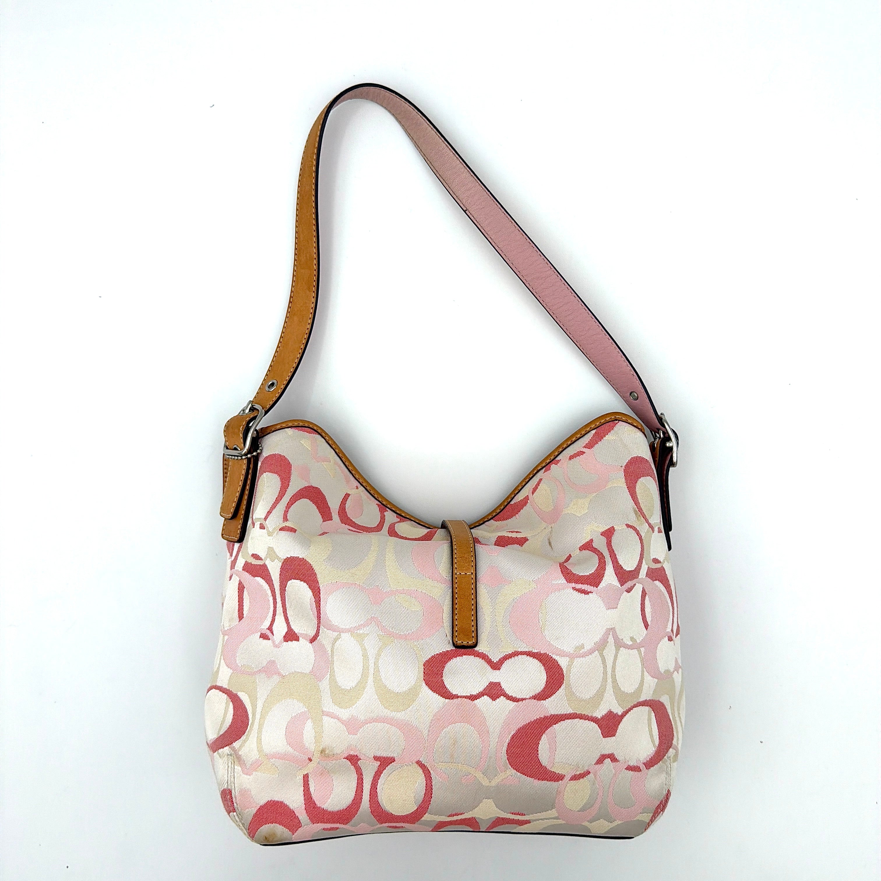 Coach hobo handbag in pink-cream canvas with signature C motif and tan leather trim, featuring a silver clip detail and a structured silhouette.