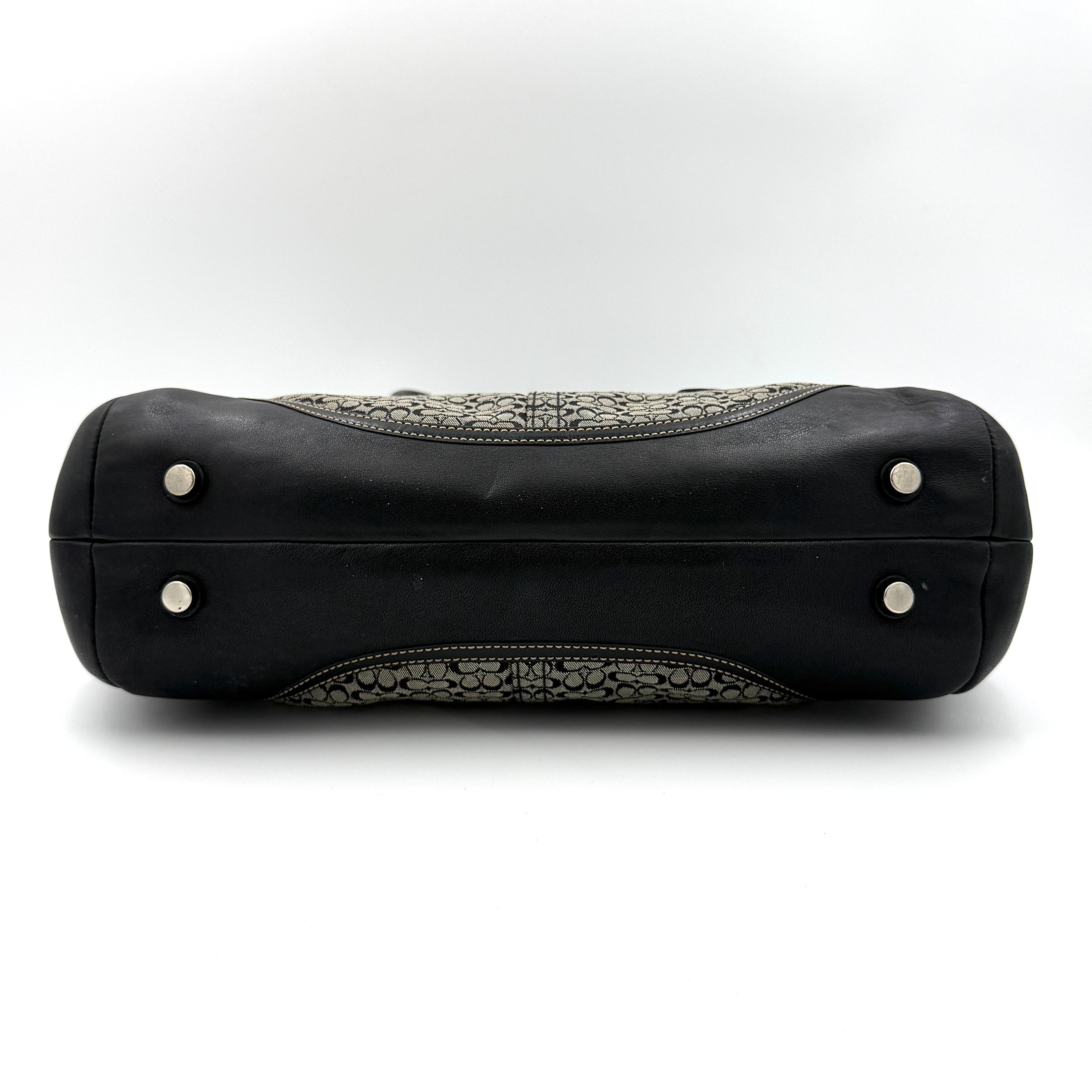 Coach Soho Hampton satchel in grey and black signature jacquard with black leather trim and silver-tone buckle details, presented upright with dual rolled handles.