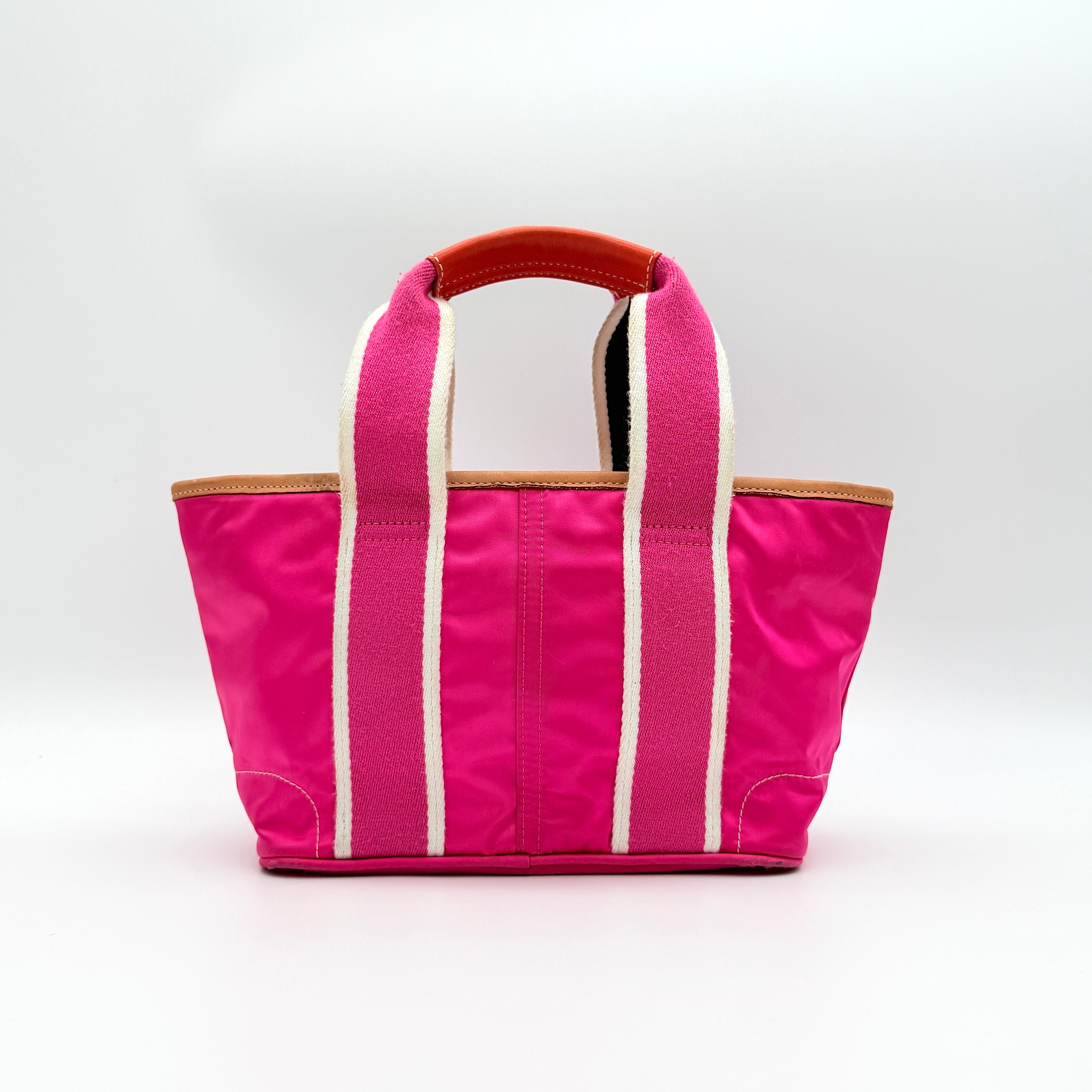 Coach Hampton Mini Tote Bag in hot pink nylon with canvas straps, leather trim, and ladybug charm.