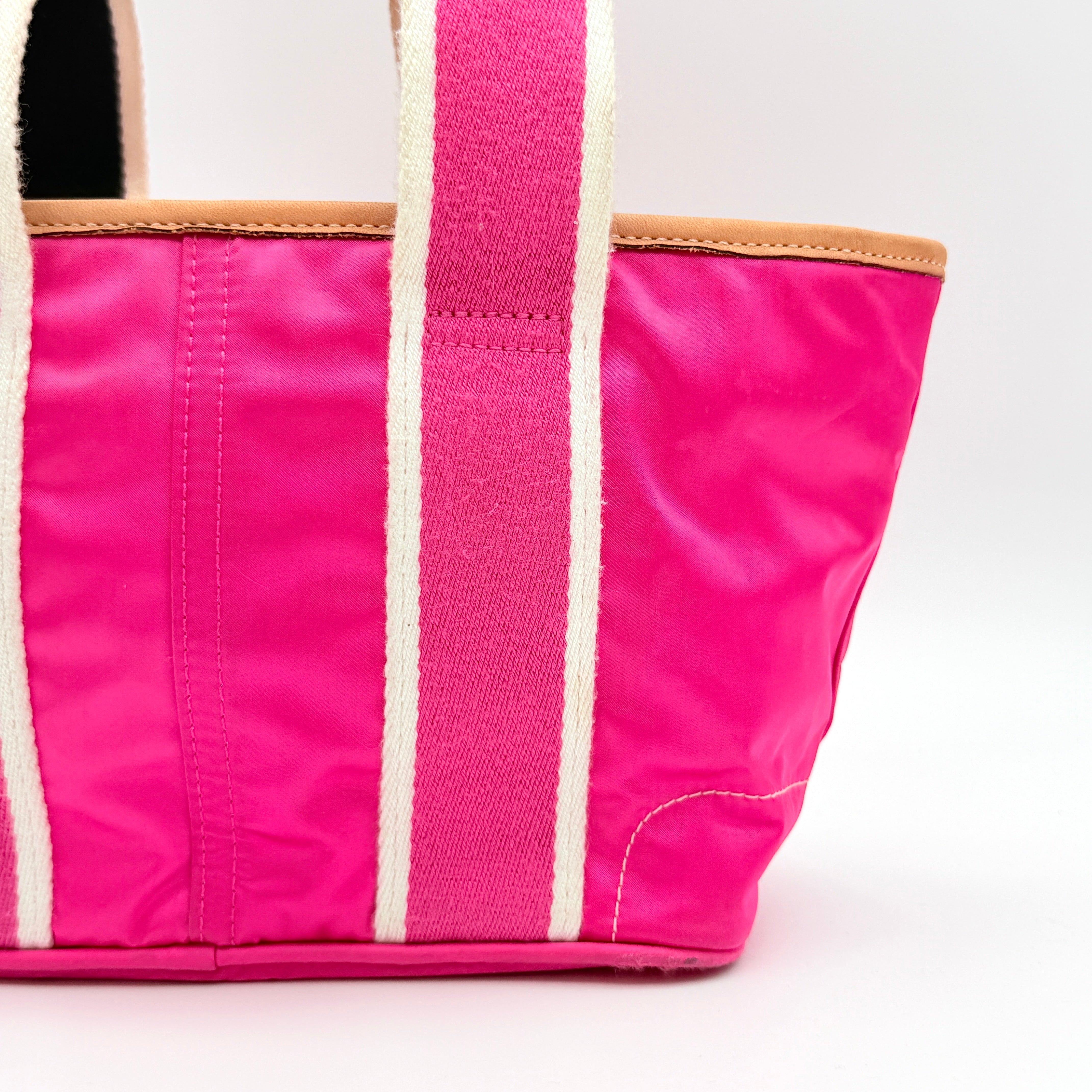 Coach Hampton Mini Tote Bag in hot pink nylon with canvas straps, leather trim, and ladybug charm.