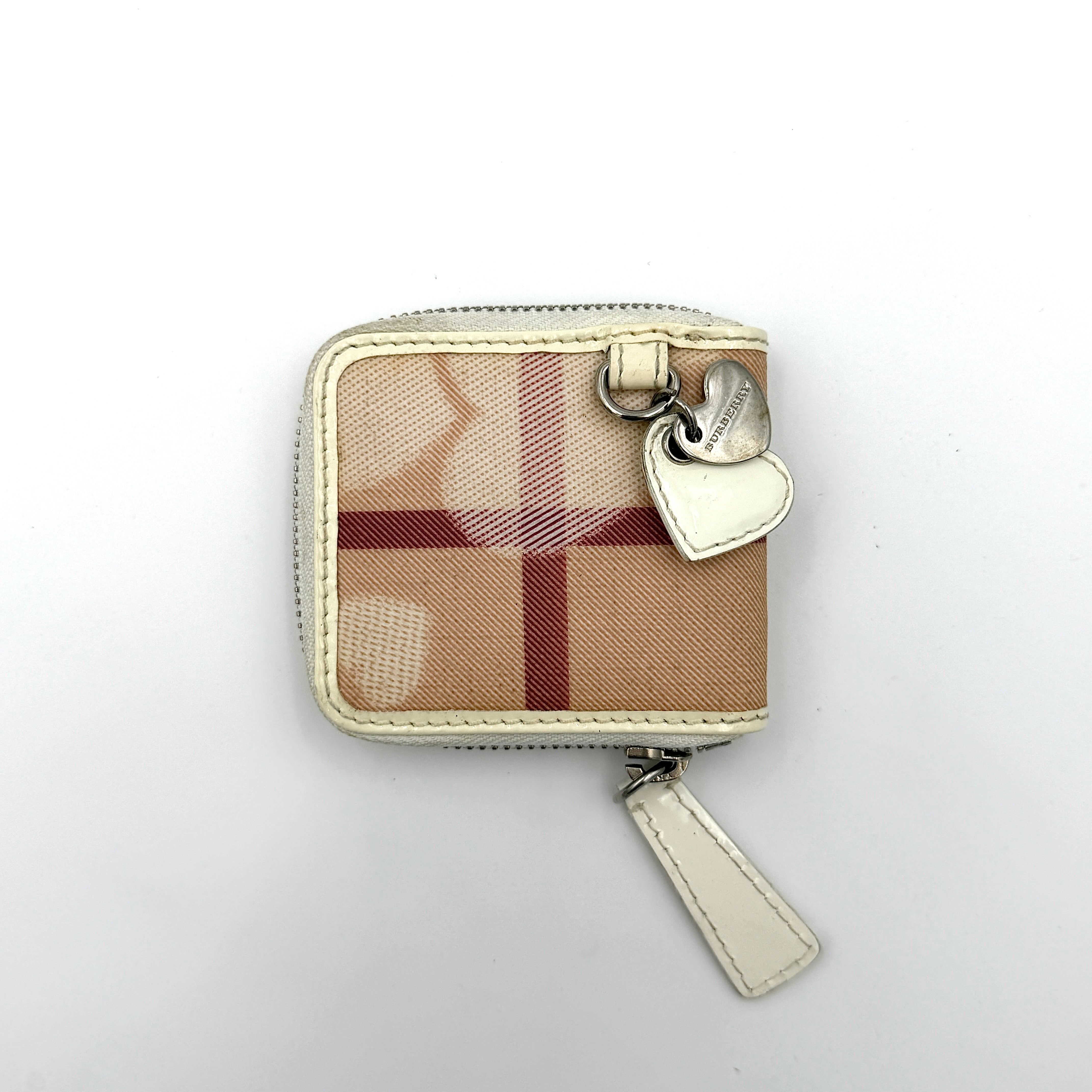 Burberry Heart Nova Check coin case in beige canvas with ivory leather trim and heart charms on the zipper pull.