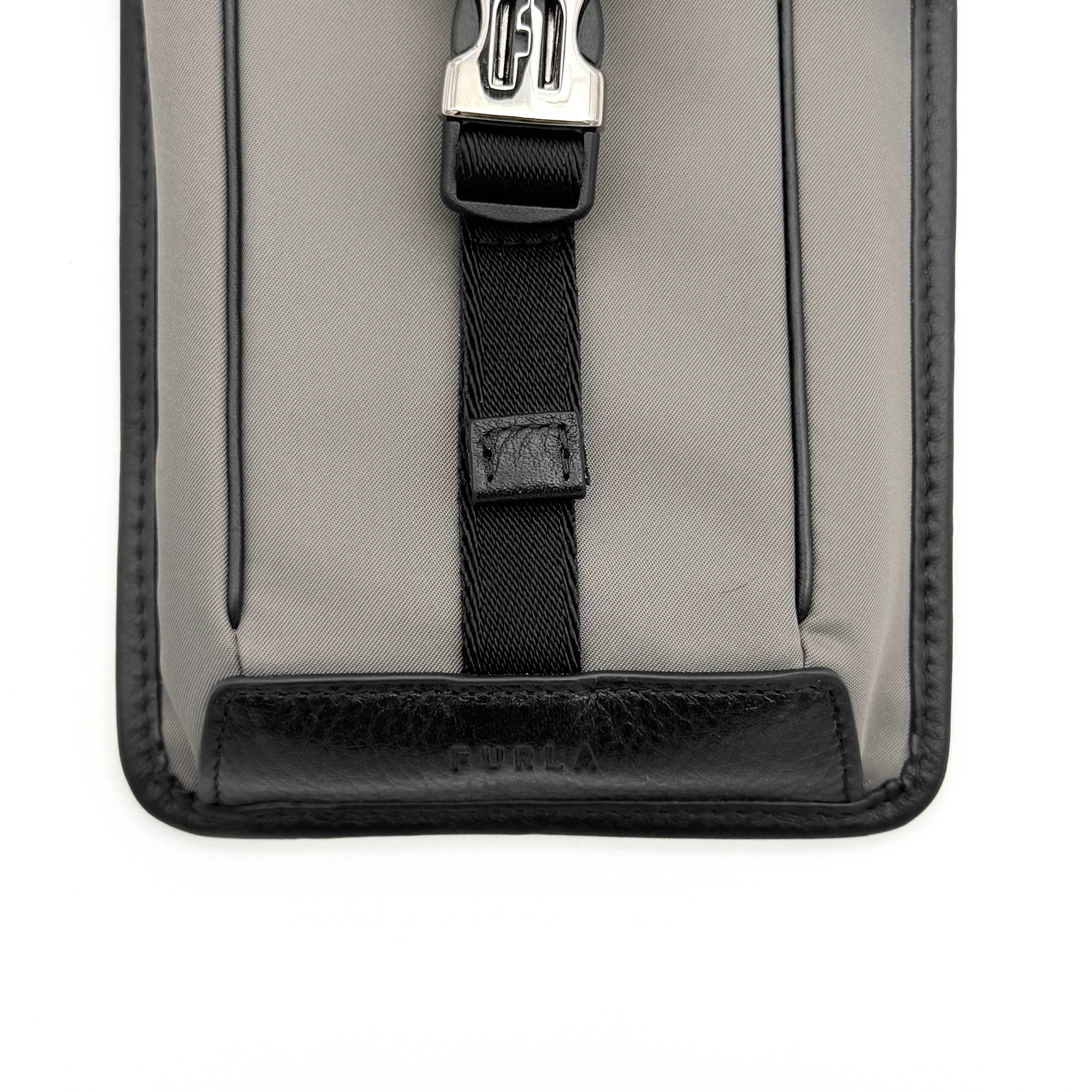 Furla Cosmo grey phone holder with black trim, silver buckle, and black cord strap on white background.
