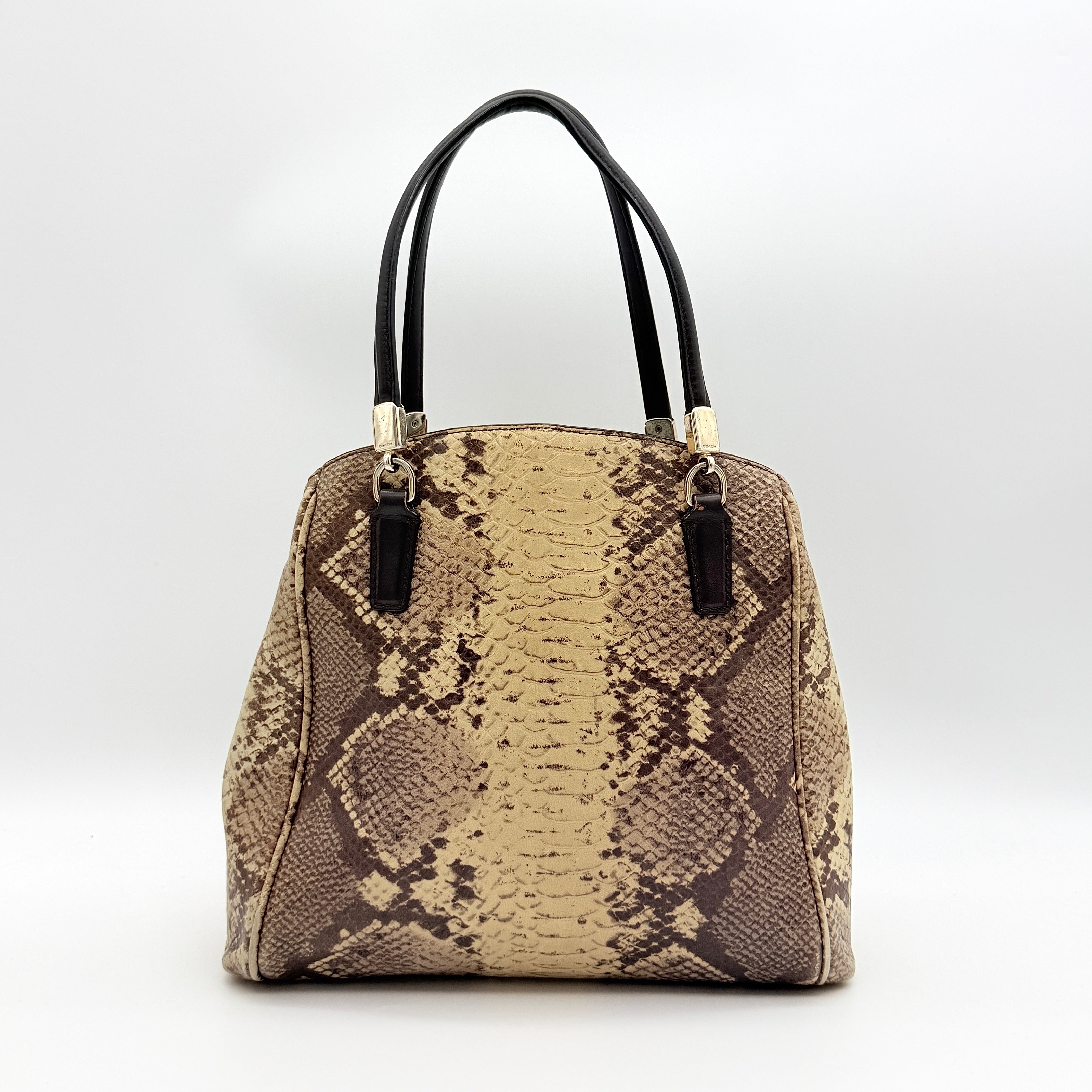 Coach Minetta shoulder bag in python-embossed beige and brown leather with black handles and gold-tone hardware.