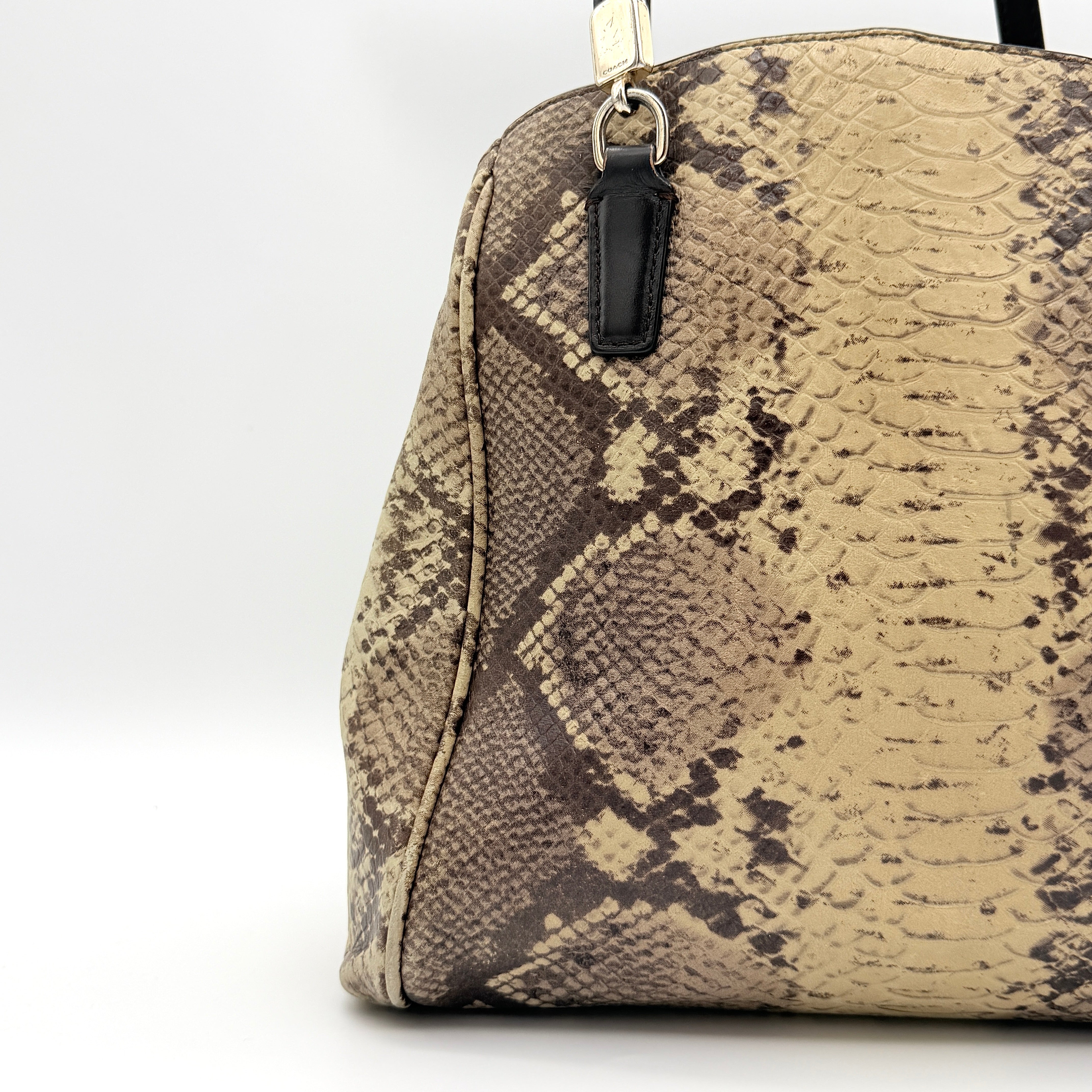 Coach Minetta shoulder bag in python-embossed beige and brown leather with black handles and gold-tone hardware.