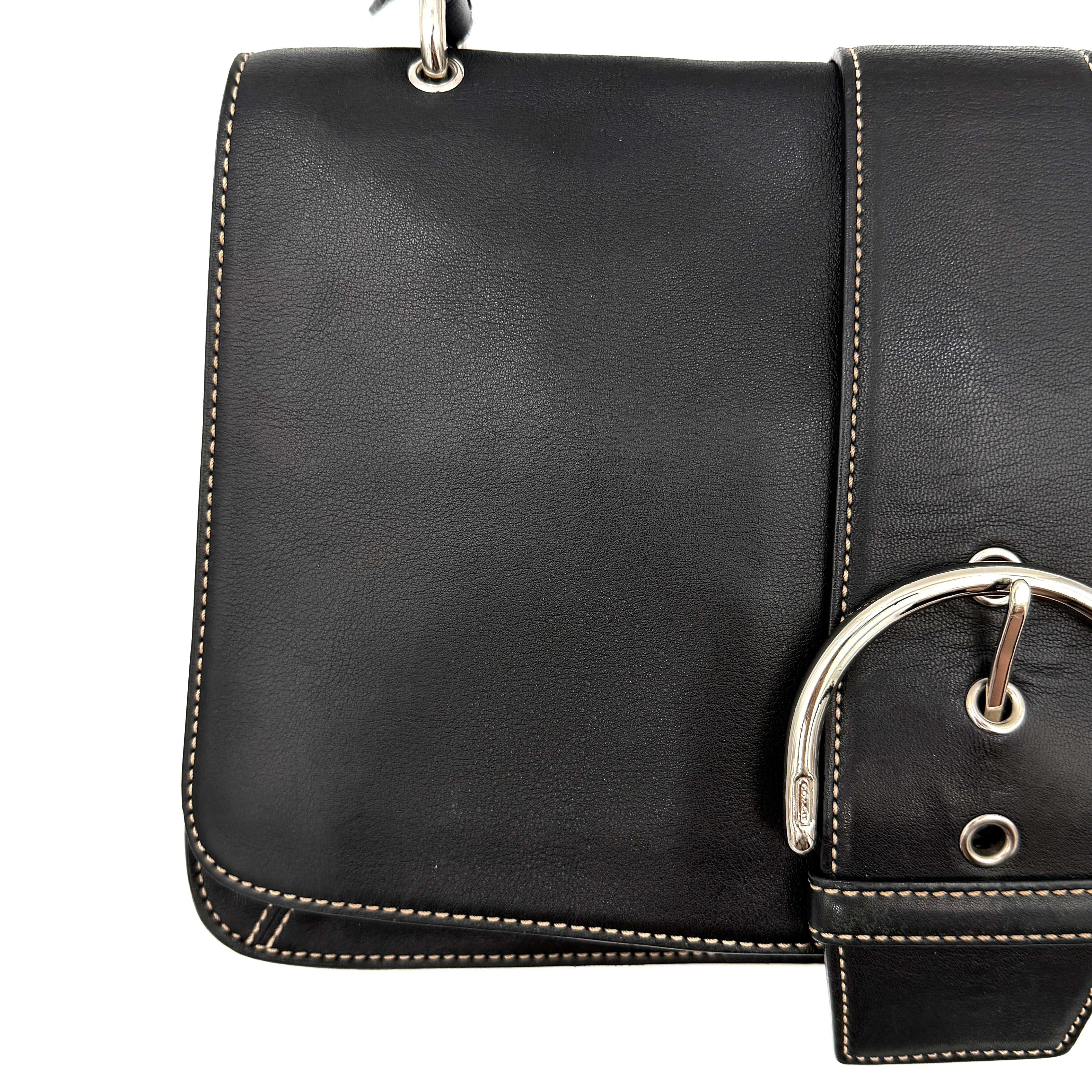 Coach Y2K Soho Buckle Shoulder Bag in smooth black leather with contrast stitching and a bold silver horseshoe buckle.