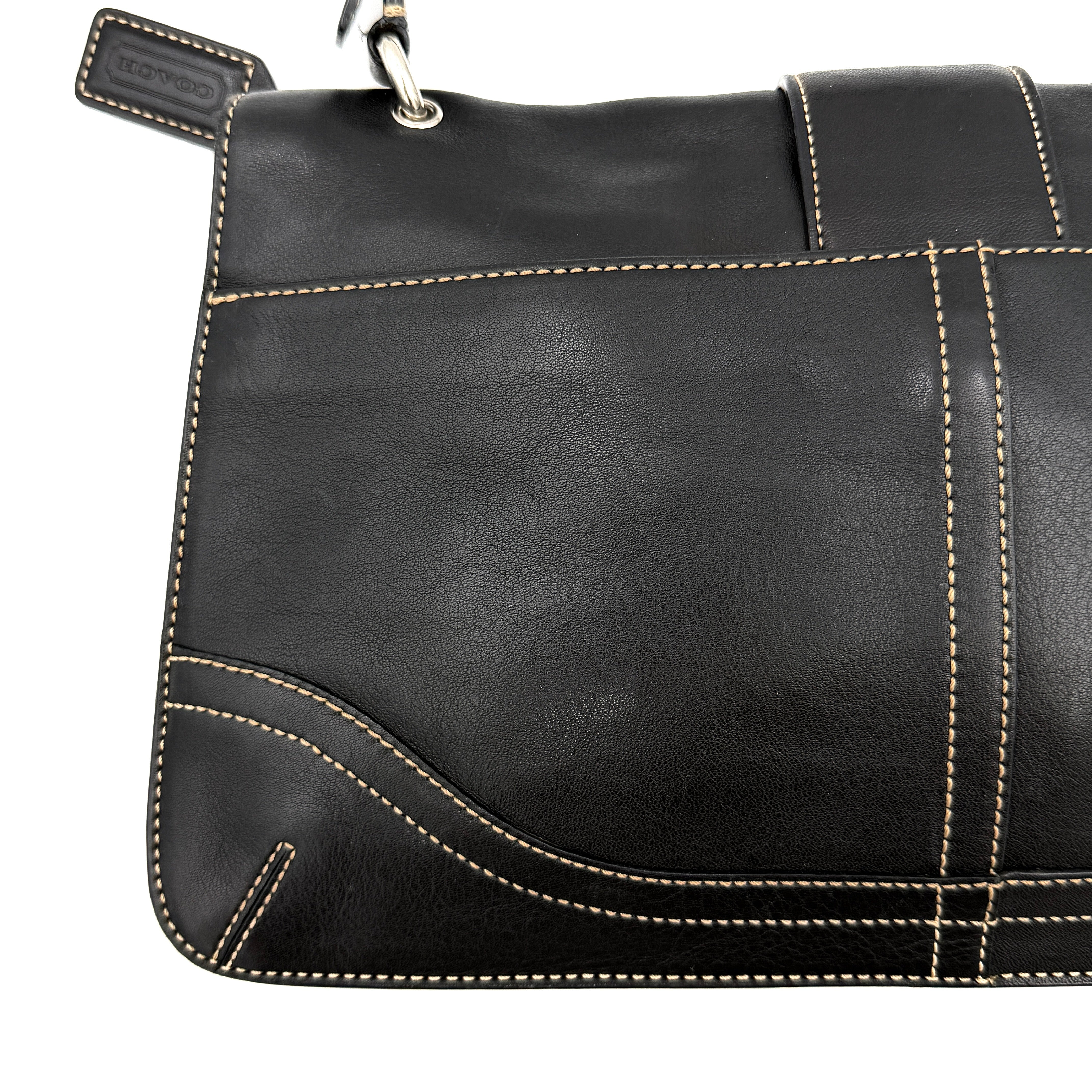 Coach Y2K Soho Buckle Shoulder Bag in smooth black leather with contrast stitching and a bold silver horseshoe buckle.