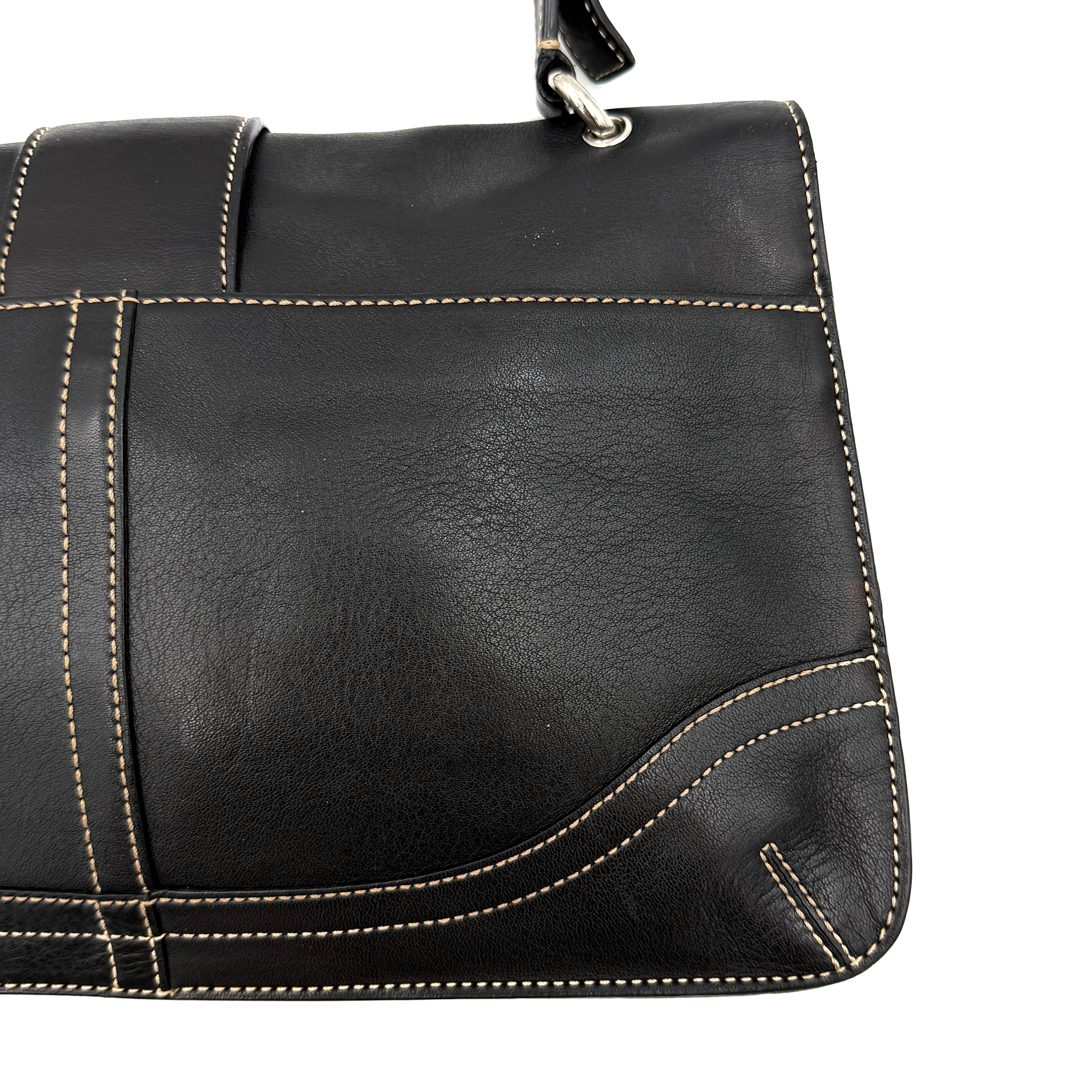 Coach Y2K Soho Buckle Shoulder Bag in smooth black leather with contrast stitching and a bold silver horseshoe buckle.