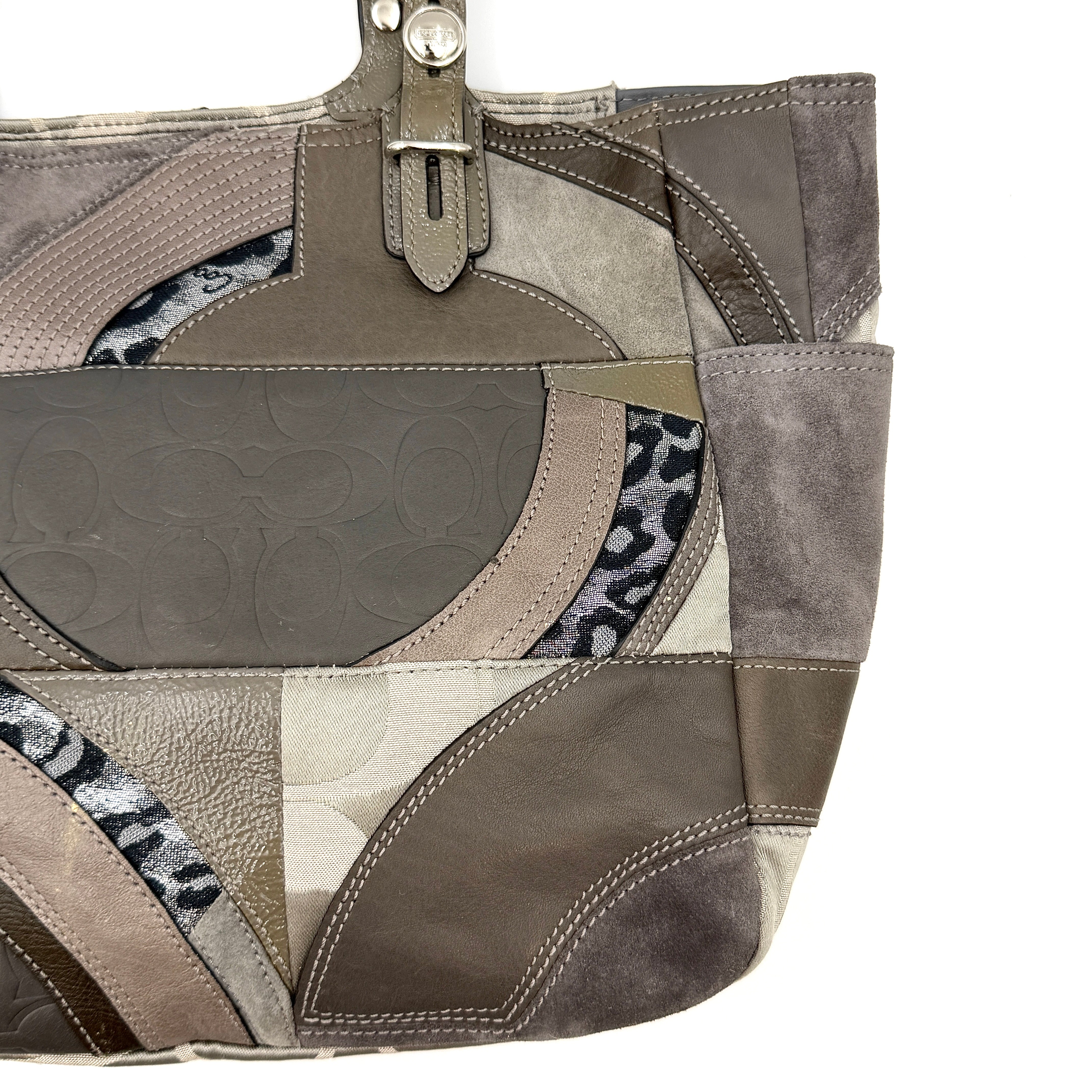 Coach Y2K patchwork tote in grey tones with jacquard, suede, and ocelot-print panels, shown with double handles and signature tag.