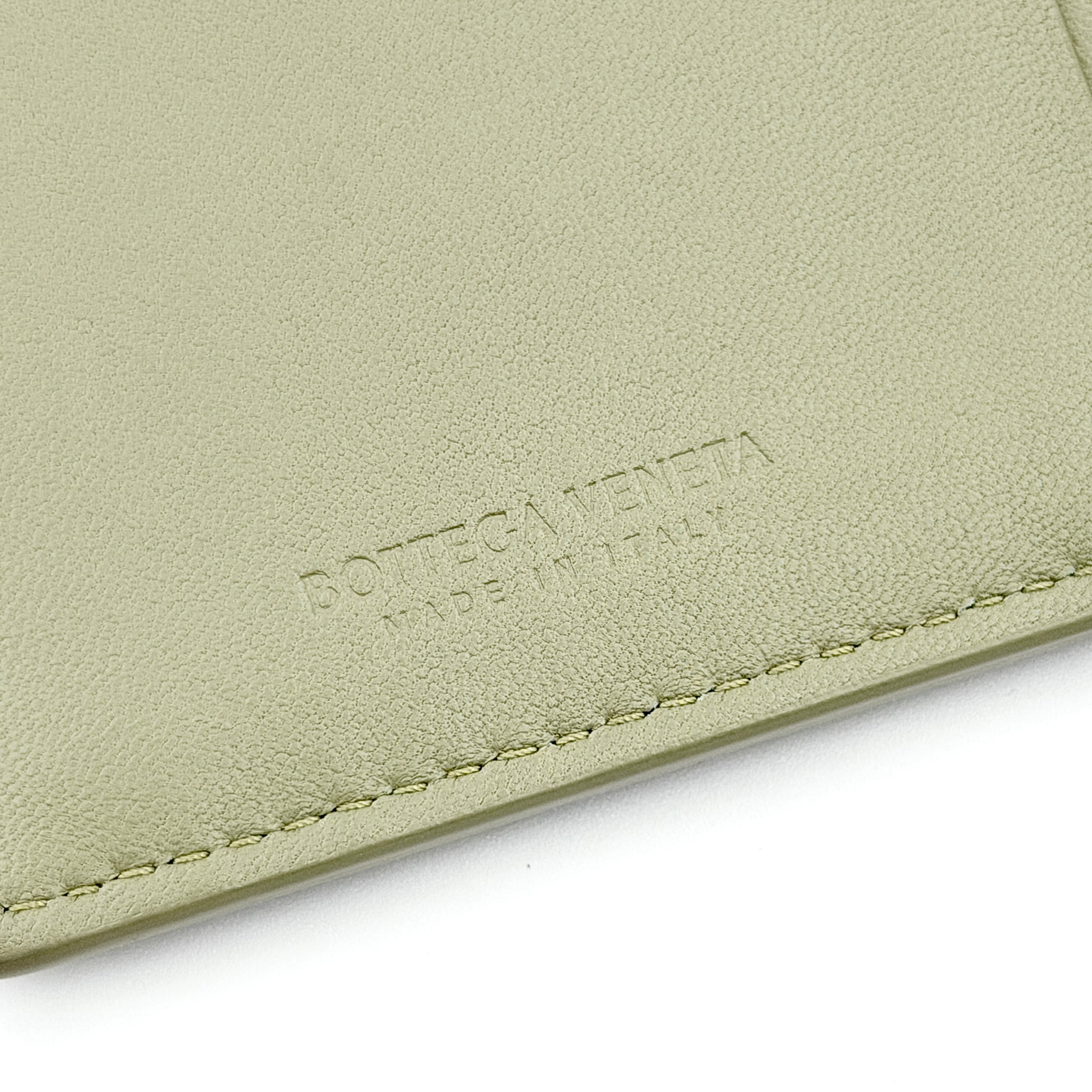Bottega Veneta Cassette card holder in travertine green leather with signature padded Intrecciato weave, photographed against a white background.