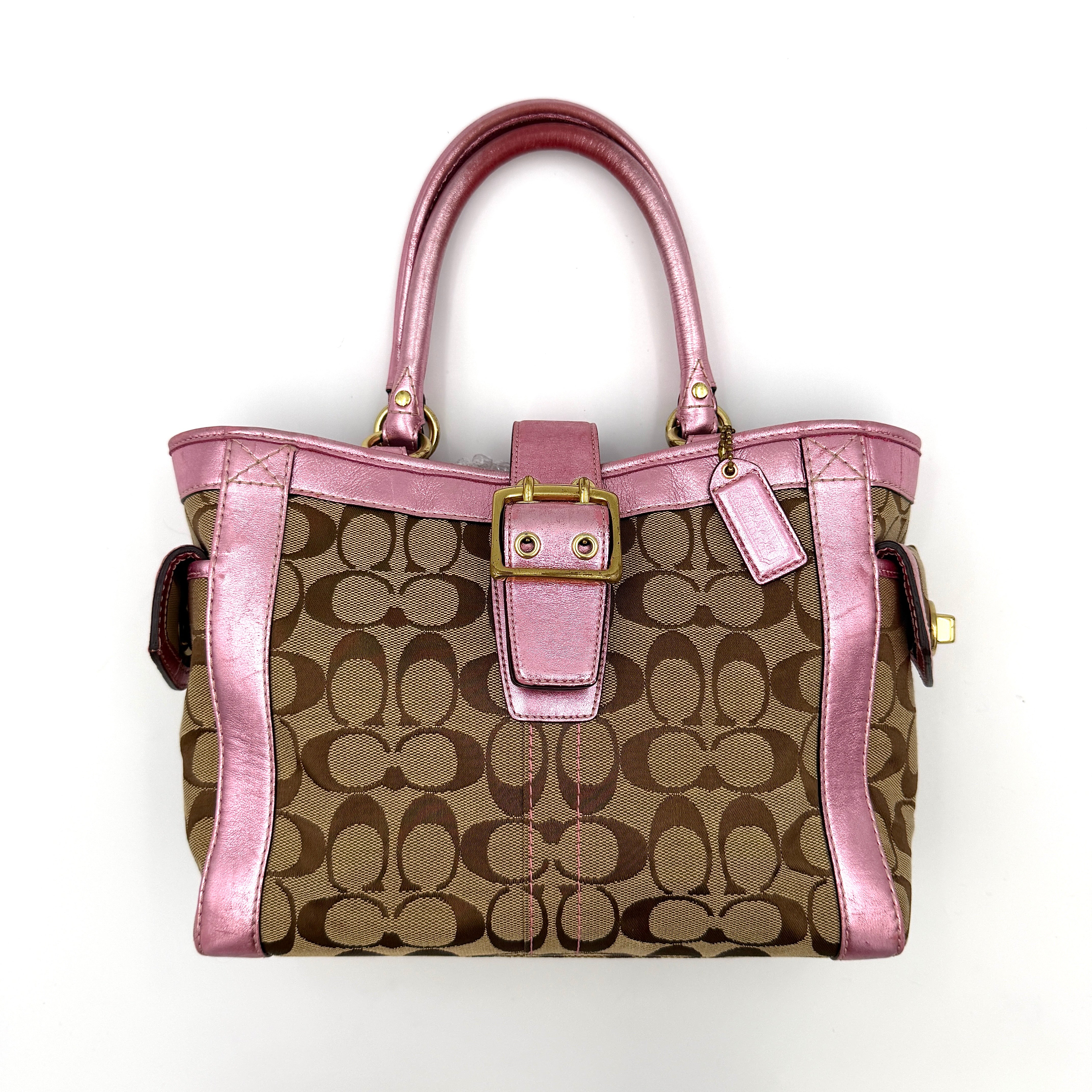 Coach Soho Buckle Tote featuring baby pink metallic leather trim and beige signature jacquard canvas with gold-tone hardware.