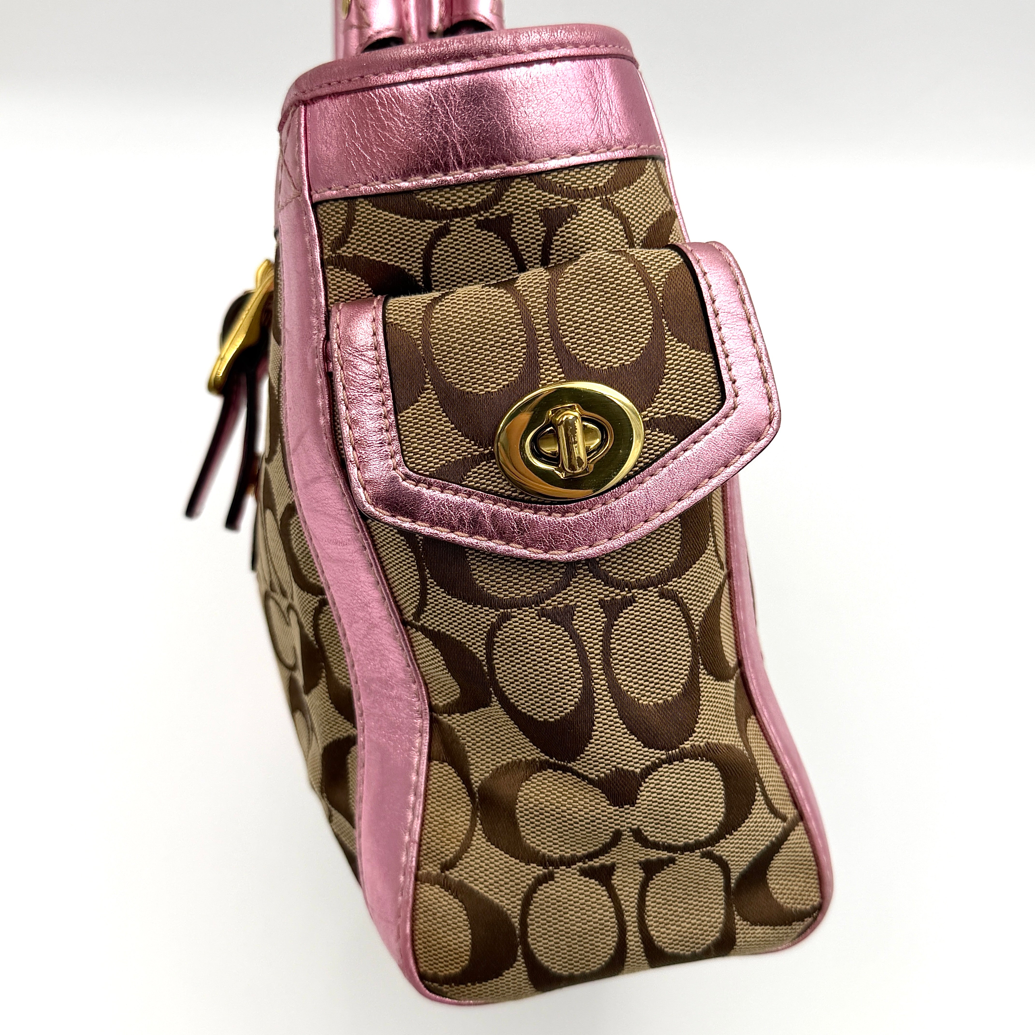 Coach Soho Buckle Tote featuring baby pink metallic leather trim and beige signature jacquard canvas with gold-tone hardware.