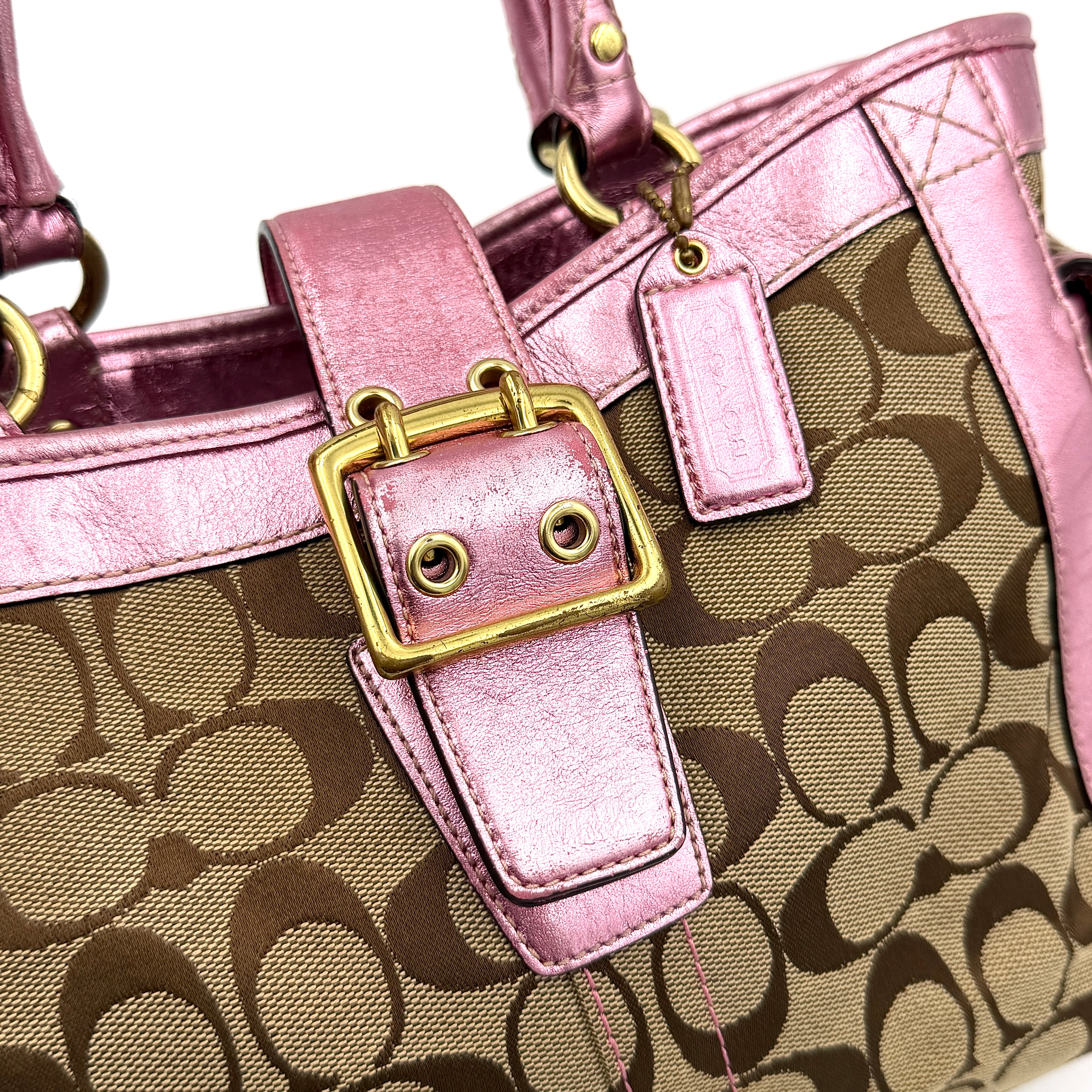 Coach Soho Buckle Tote featuring baby pink metallic leather trim and beige signature jacquard canvas with gold-tone hardware.