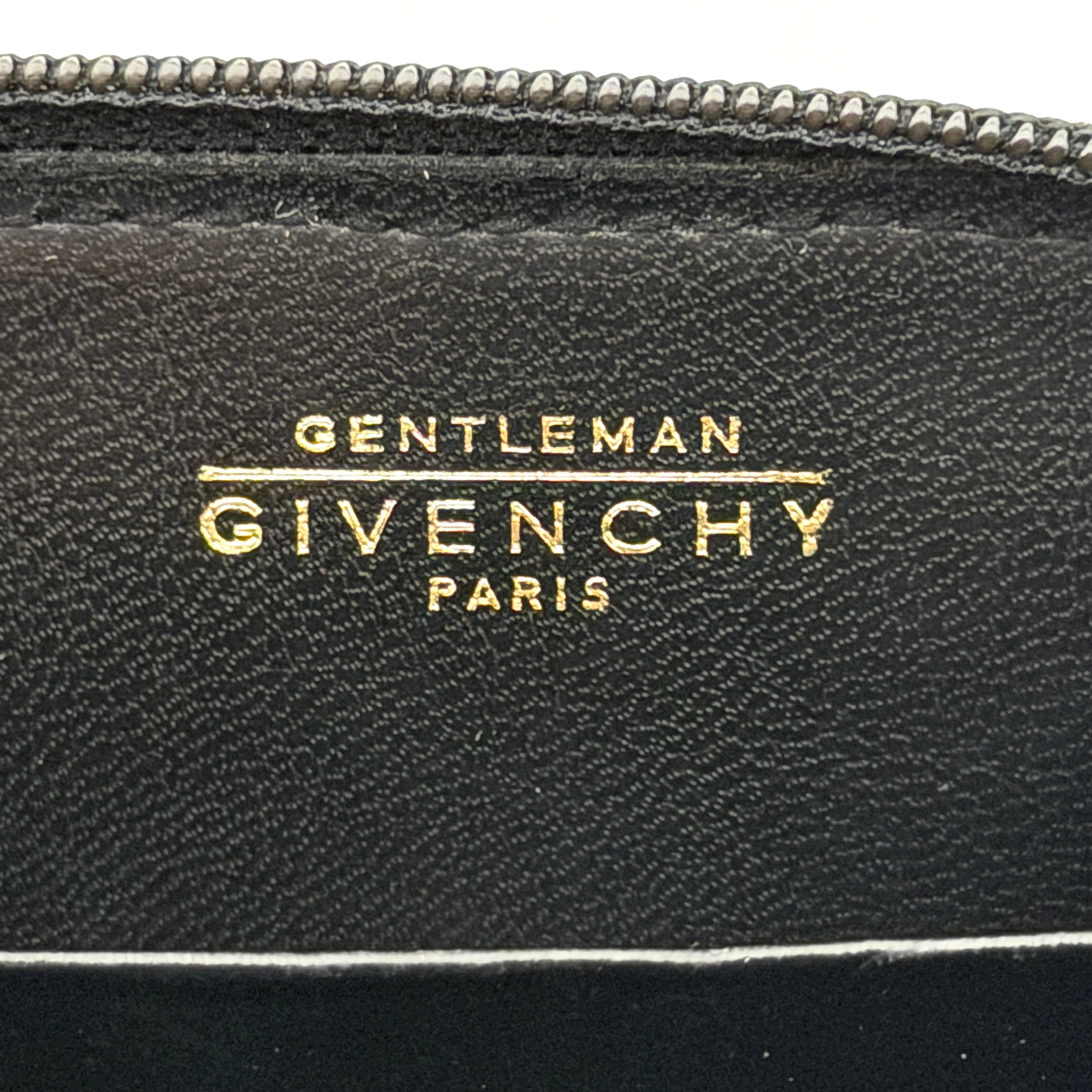 Givenchy Gentleman black leather coin purse with zip-around closure, shown against a white background.