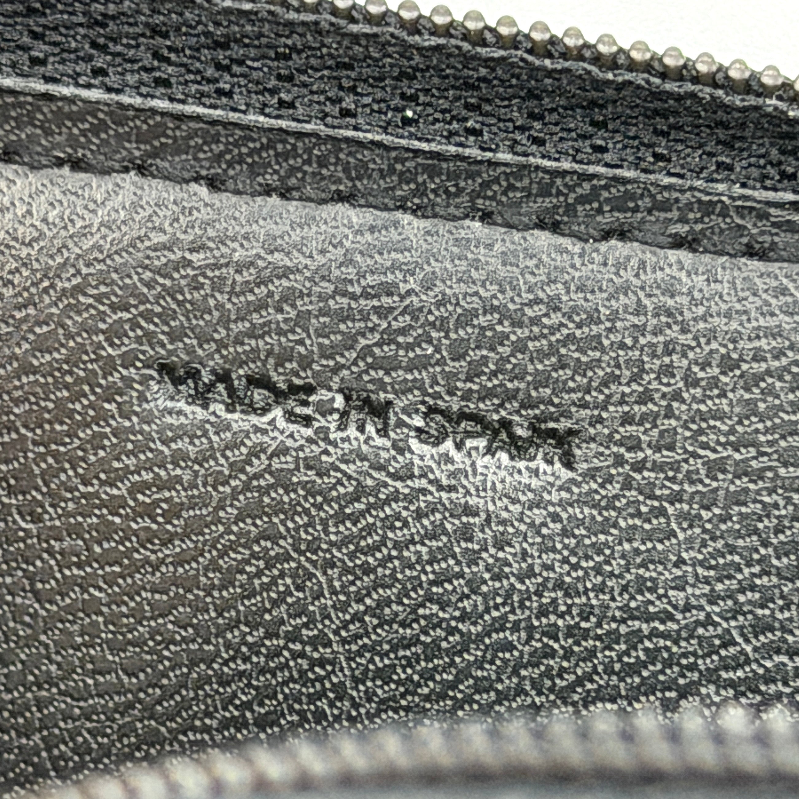 Givenchy Gentleman black leather coin purse with zip-around closure, shown against a white background.
