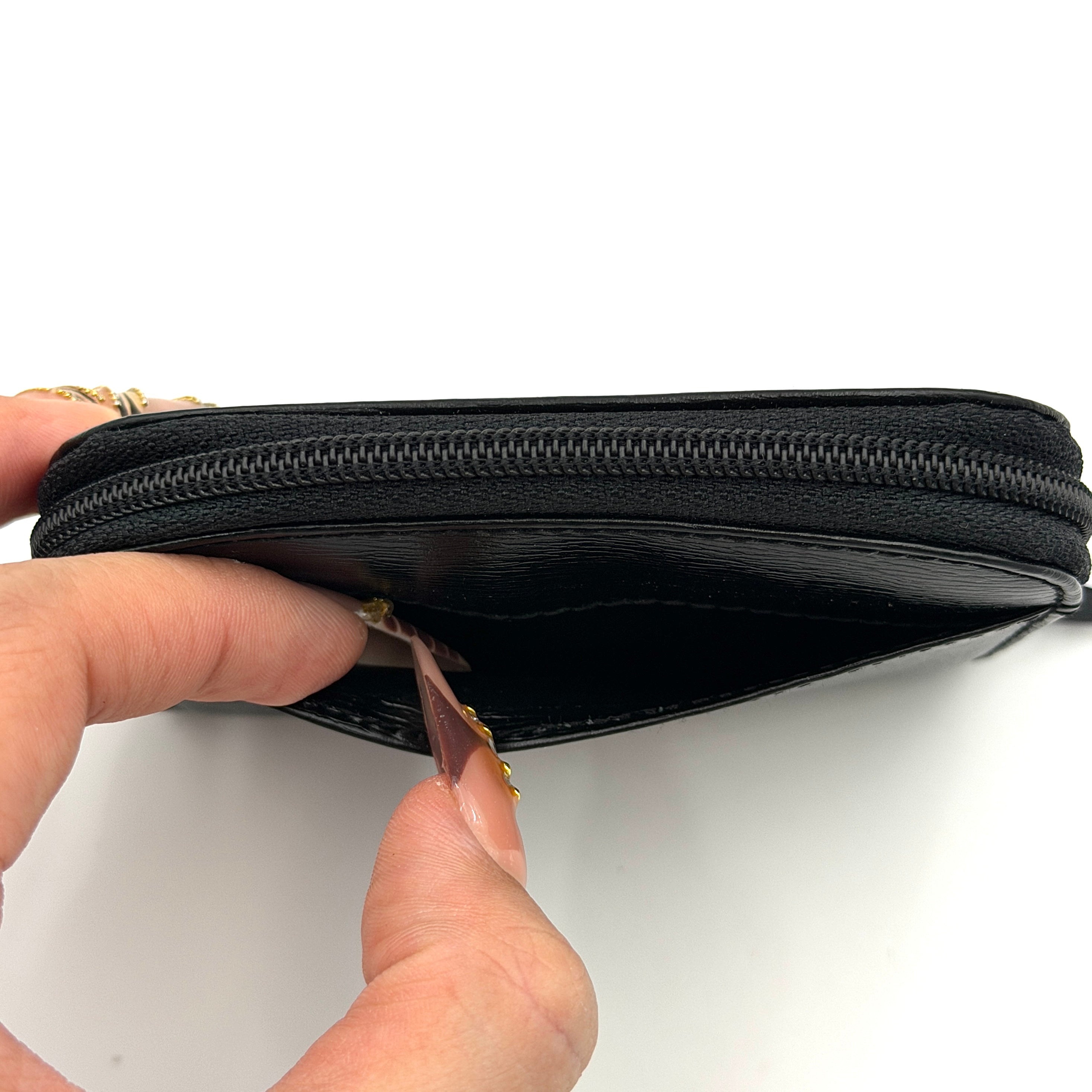 Givenchy Gentleman black leather coin purse with zip-around closure, shown against a white background.