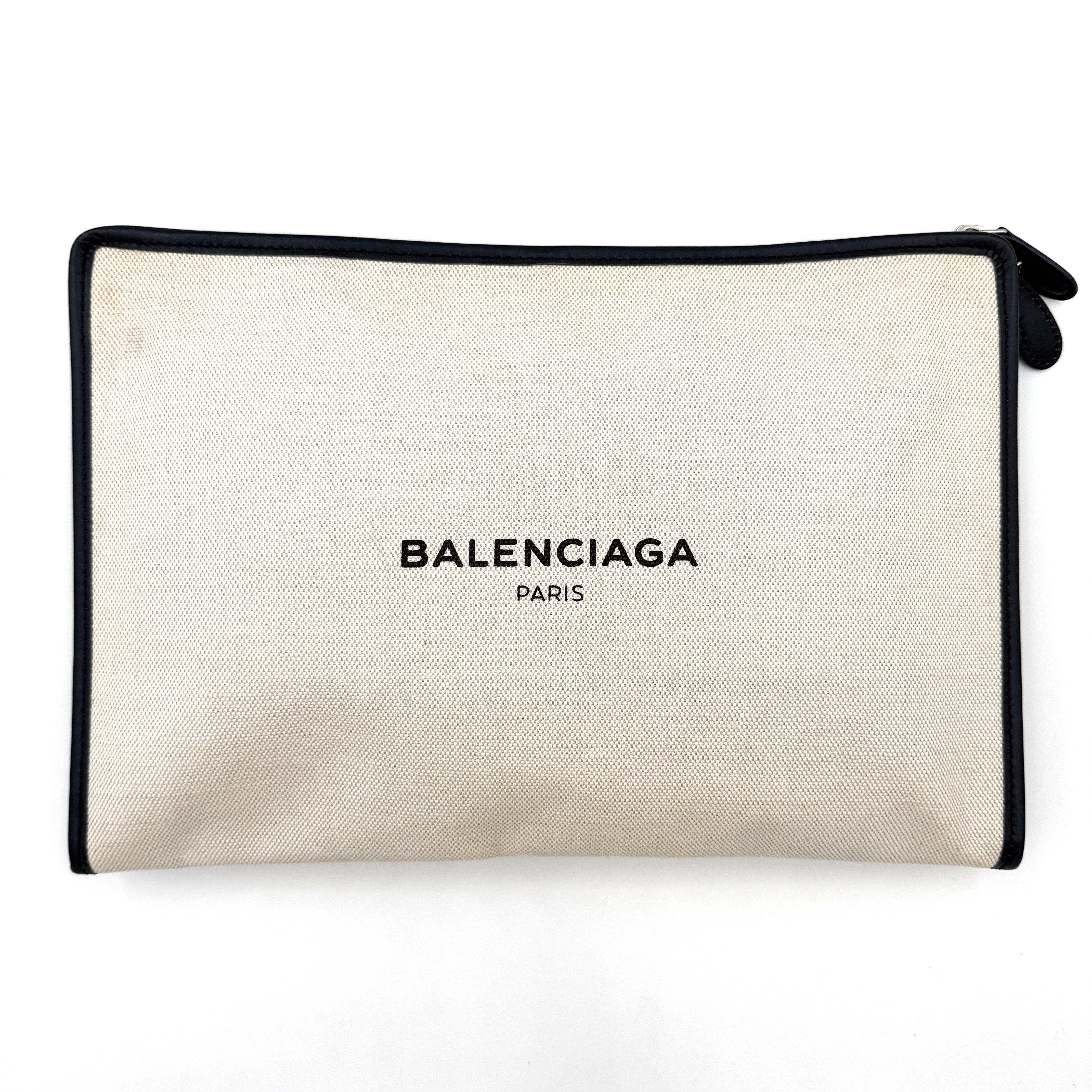 Balenciaga large ivory canvas clutch with black leather trim and logo, shown against a plain background.