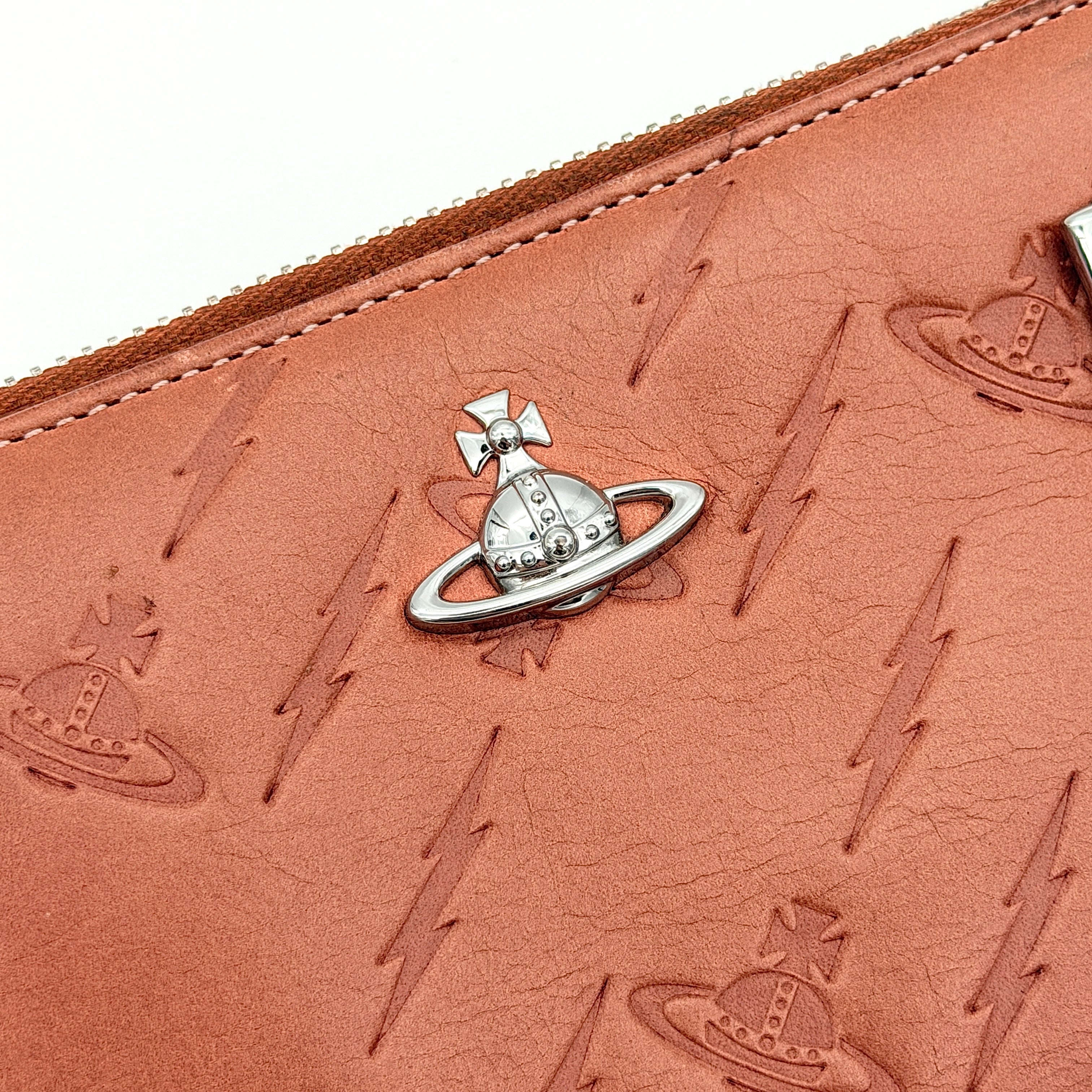 Vivienne Westwood 2Way Signature Orb Embossed Shoulder Wallet in coral pink leather with removable shoulder strap, shown with silver hardware.