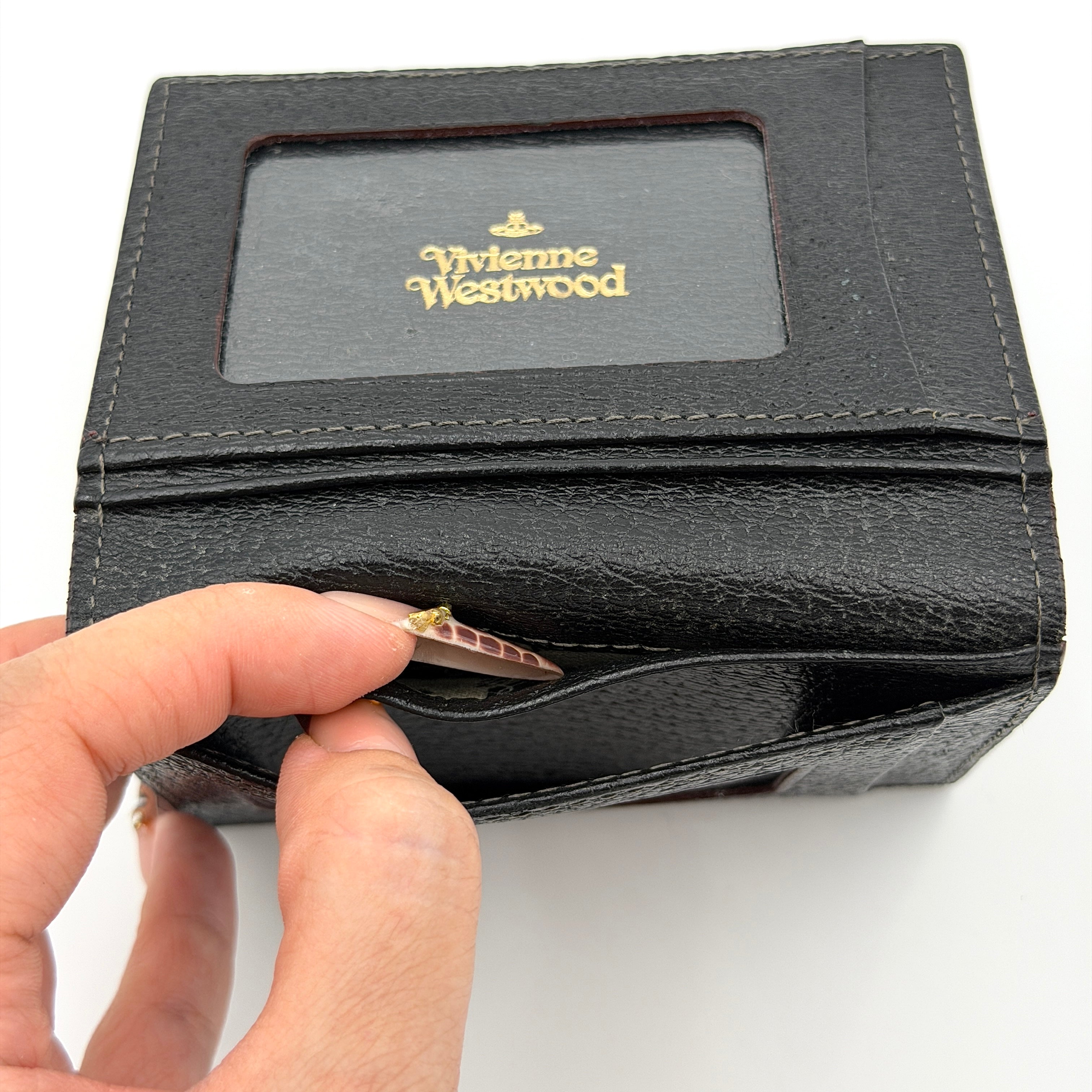 Vivienne Westwood black grained leather cardholder with gold orb emblem on the front flap.