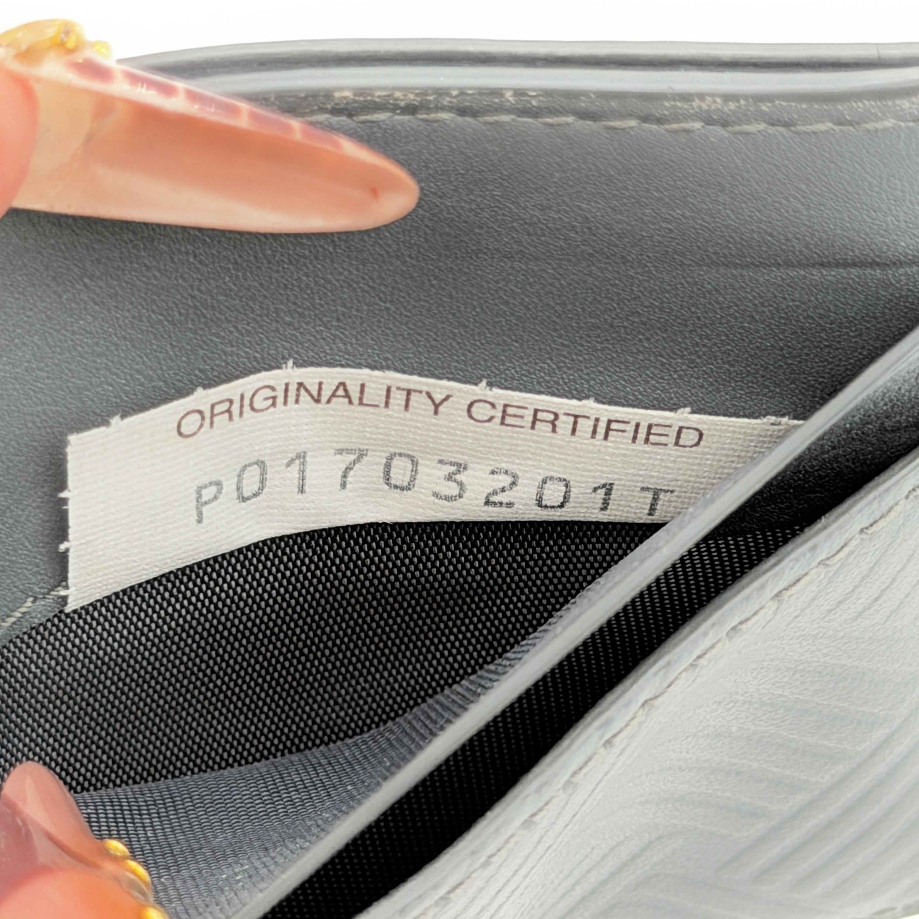 Bottega Veneta grey leather card holder with embossed geometric weave detail, photographed against a white background.