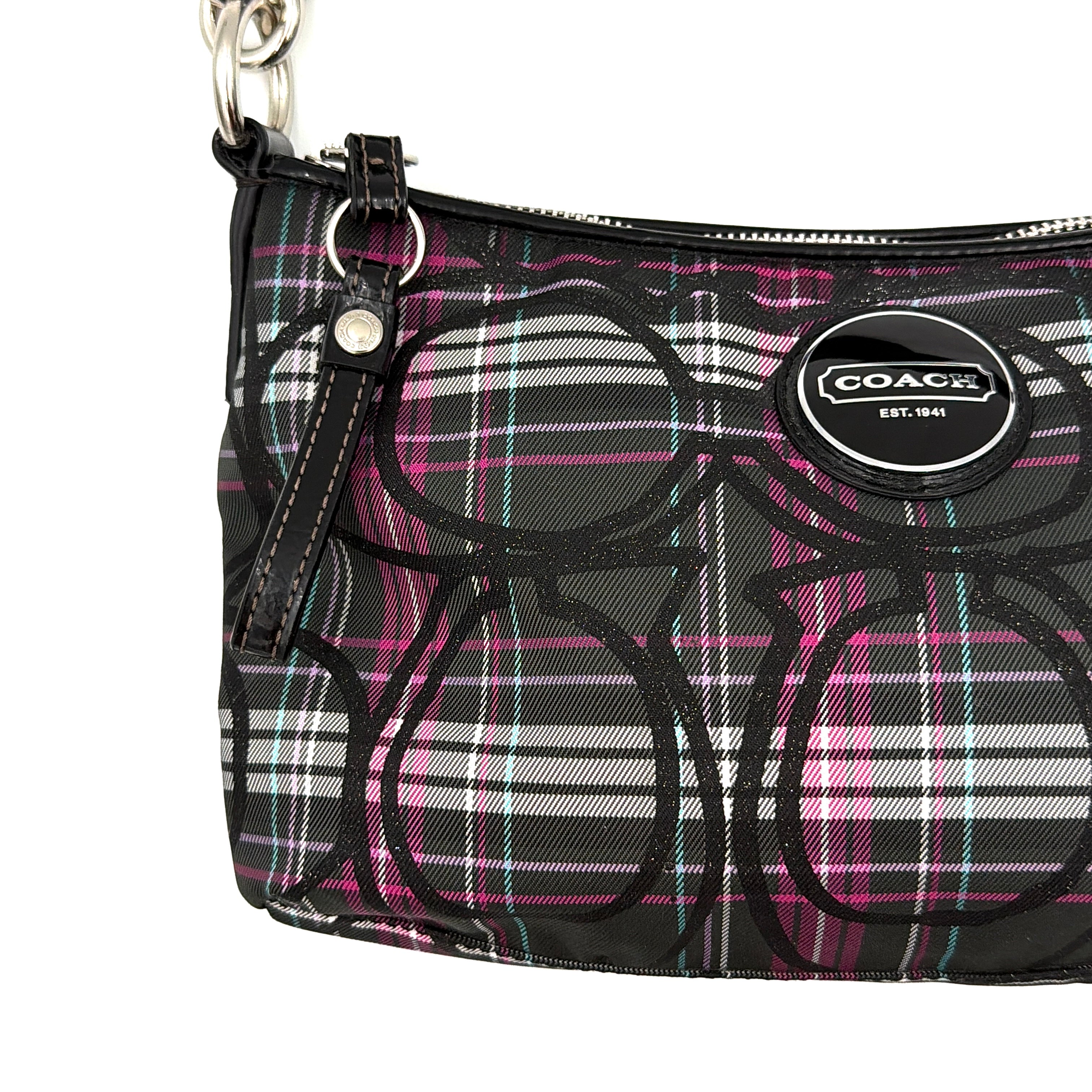 Coach Poppy tartan shoulder bag in black, magenta, and teal plaid with detachable black leather strap and silver-tone hardware.