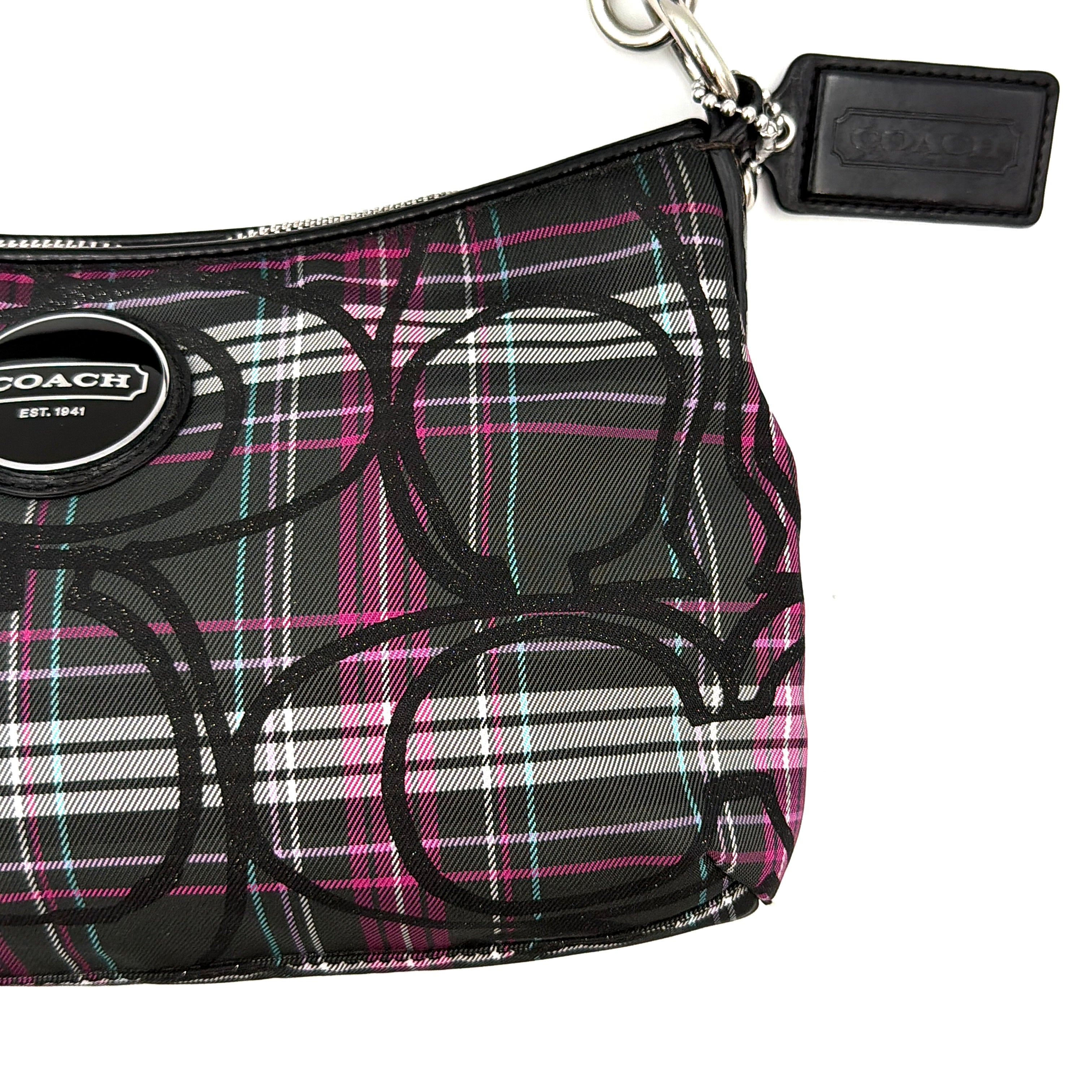 Coach Poppy tartan shoulder bag in black, magenta, and teal plaid with detachable black leather strap and silver-tone hardware.