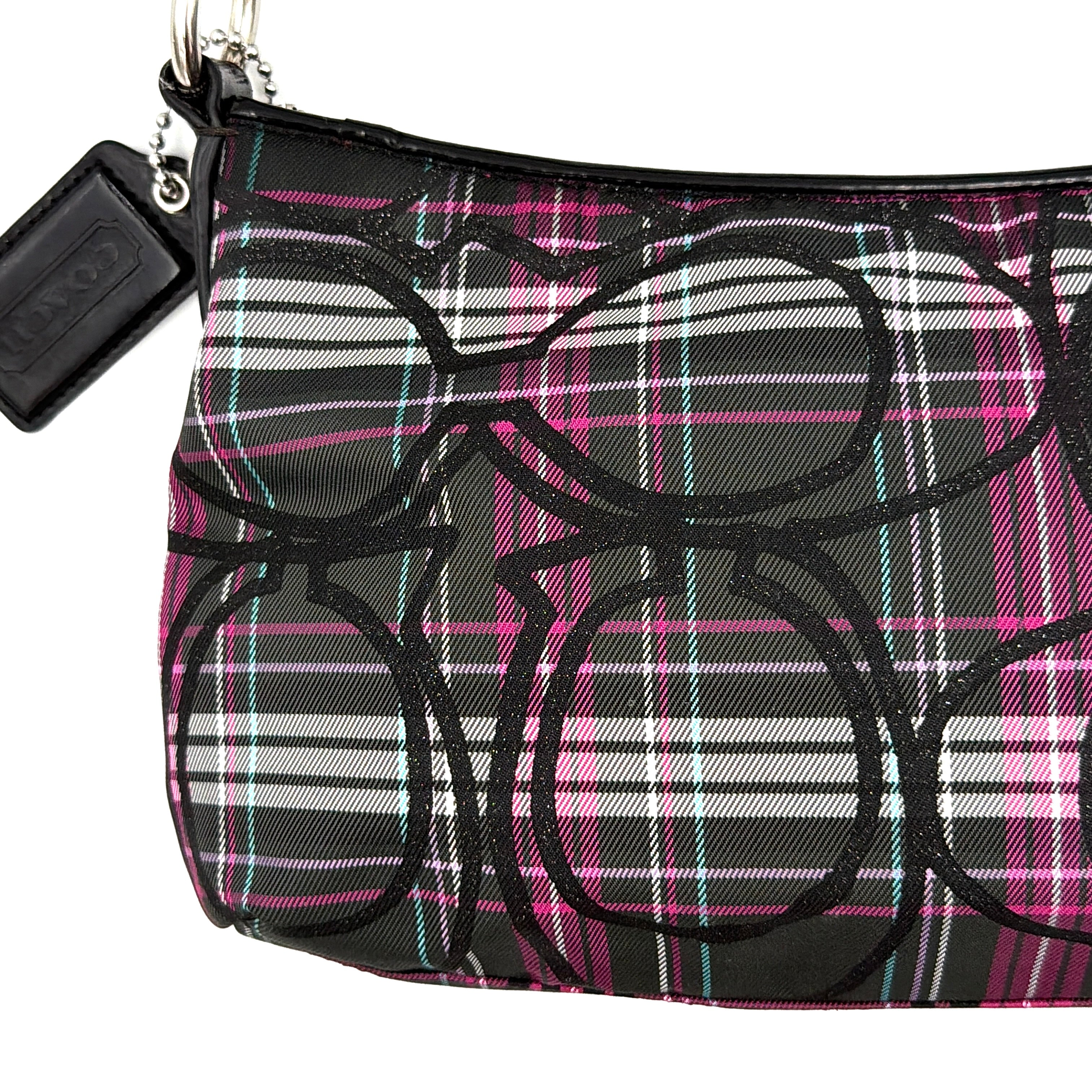 Coach Poppy tartan shoulder bag in black, magenta, and teal plaid with detachable black leather strap and silver-tone hardware.