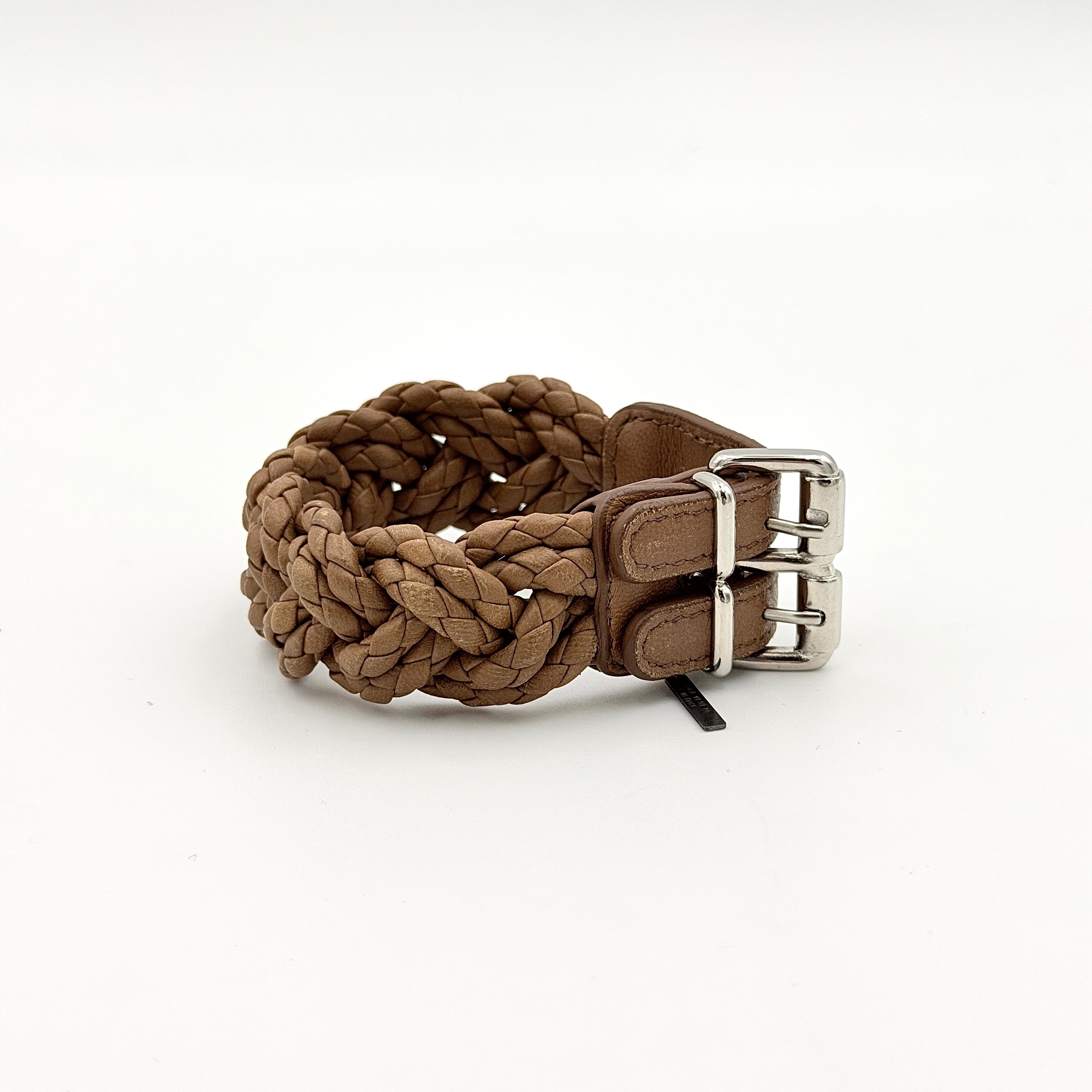 Bottega Veneta brown braided leather bracelet with silver-tone double buckle, displayed on a clean background.