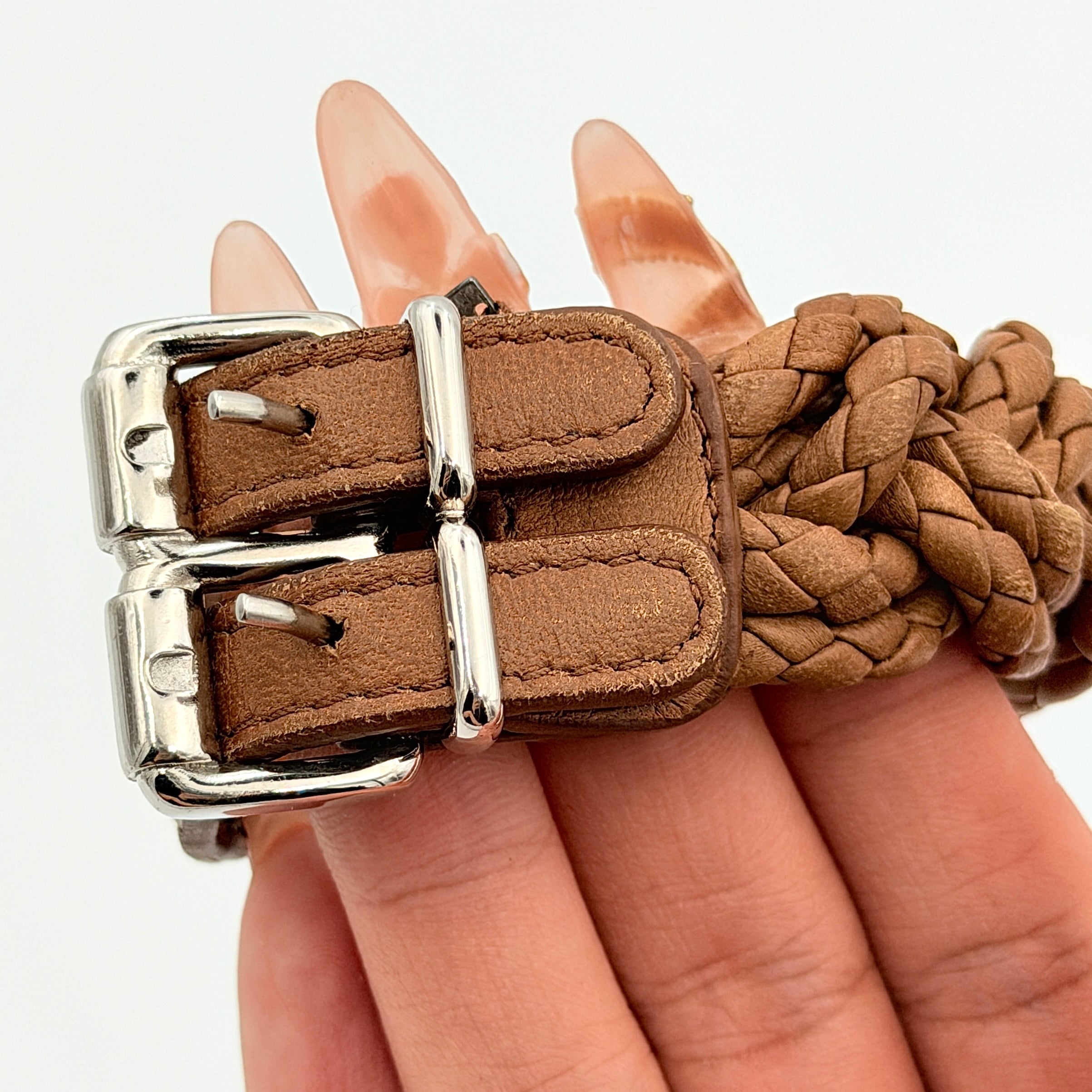 Bottega Veneta brown braided leather bracelet with silver-tone double buckle, displayed on a clean background.