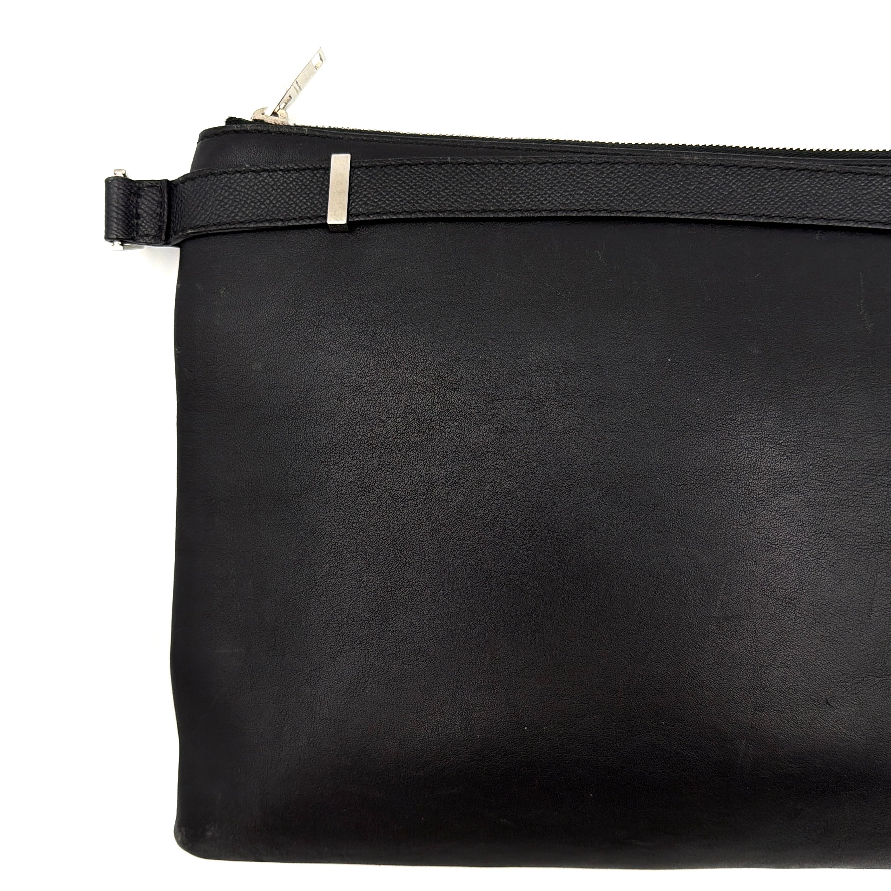 Balenciaga Phileas clutch in smooth black leather with silver hardware, shown against a white background.