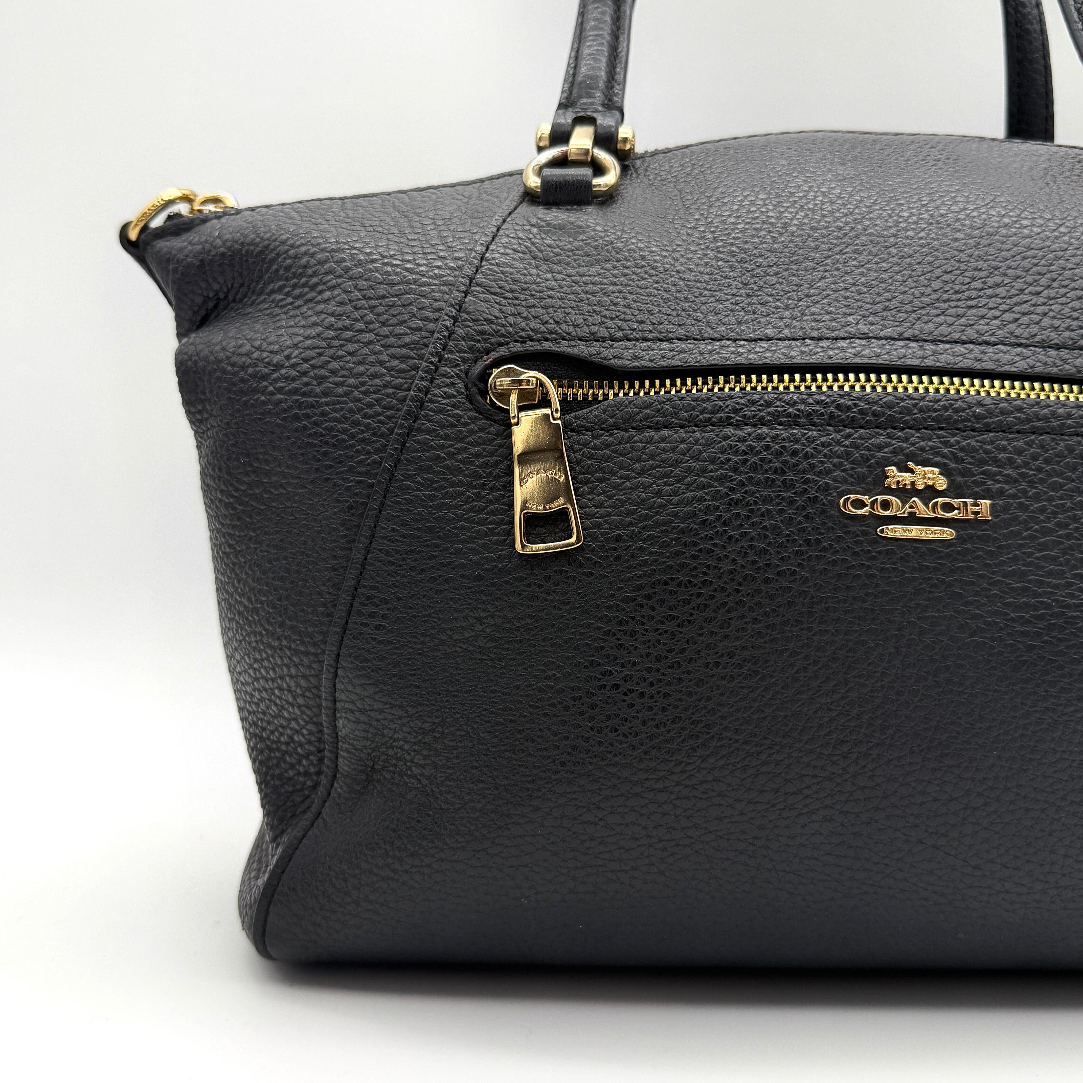 Coach 2Way Prairie Satchel in black grained leather with gold-tone hardware, shown with detachable strap and branded dust bag.