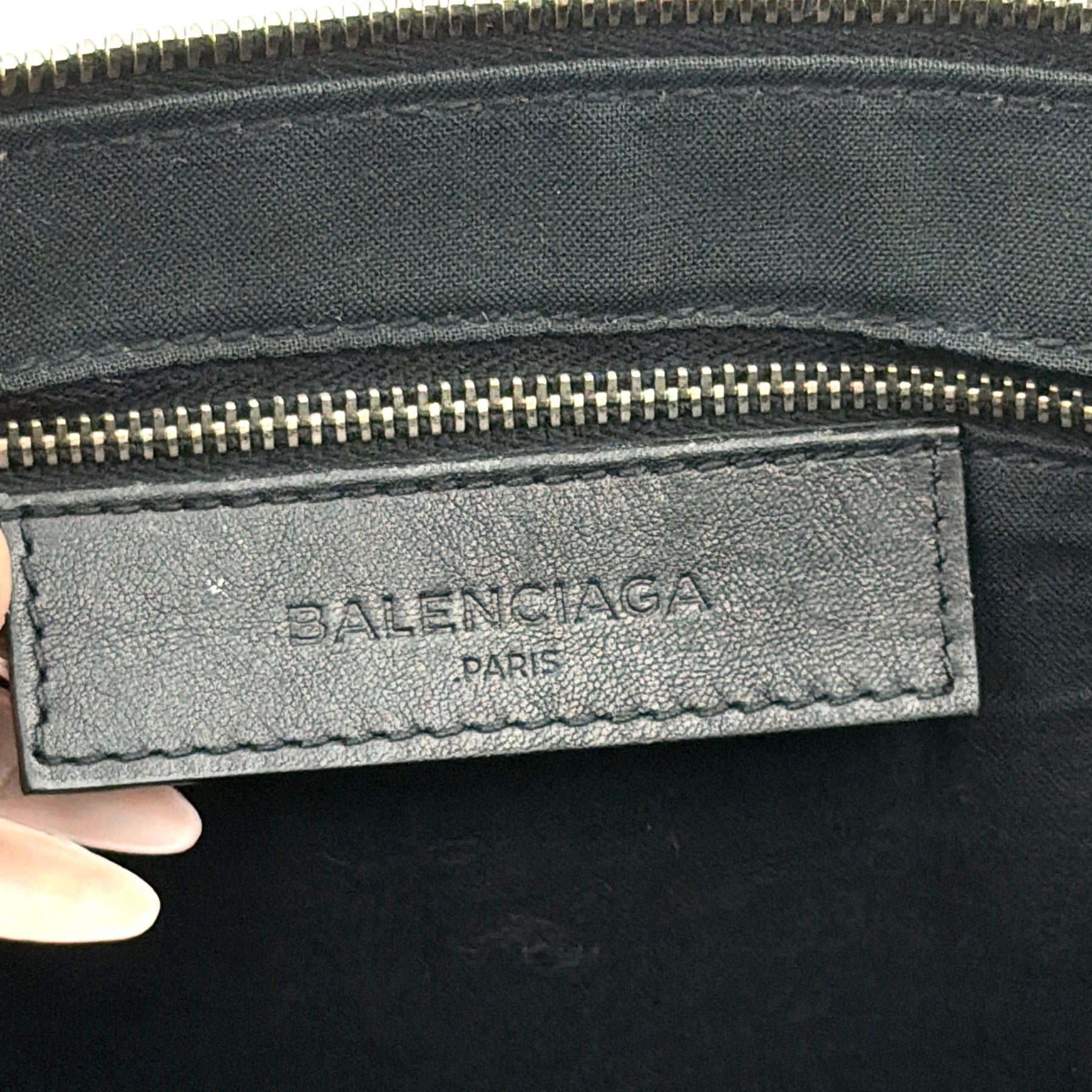 Balenciaga Phileas clutch in smooth black leather with silver hardware, shown against a white background.