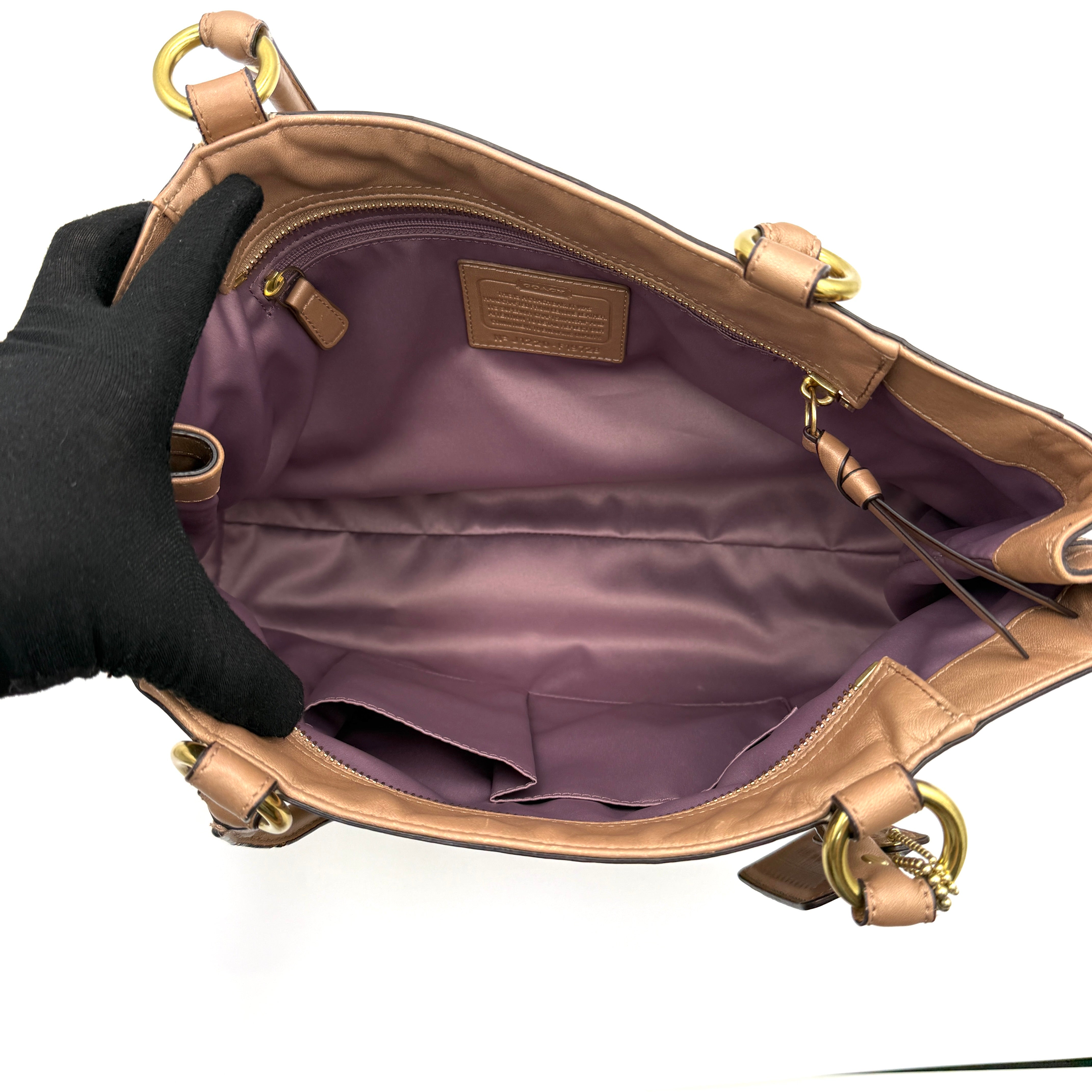 Coach Park Leather Carryall in beige leather with gold-tone hardware and double handles, styled with signature Coach hangtags.