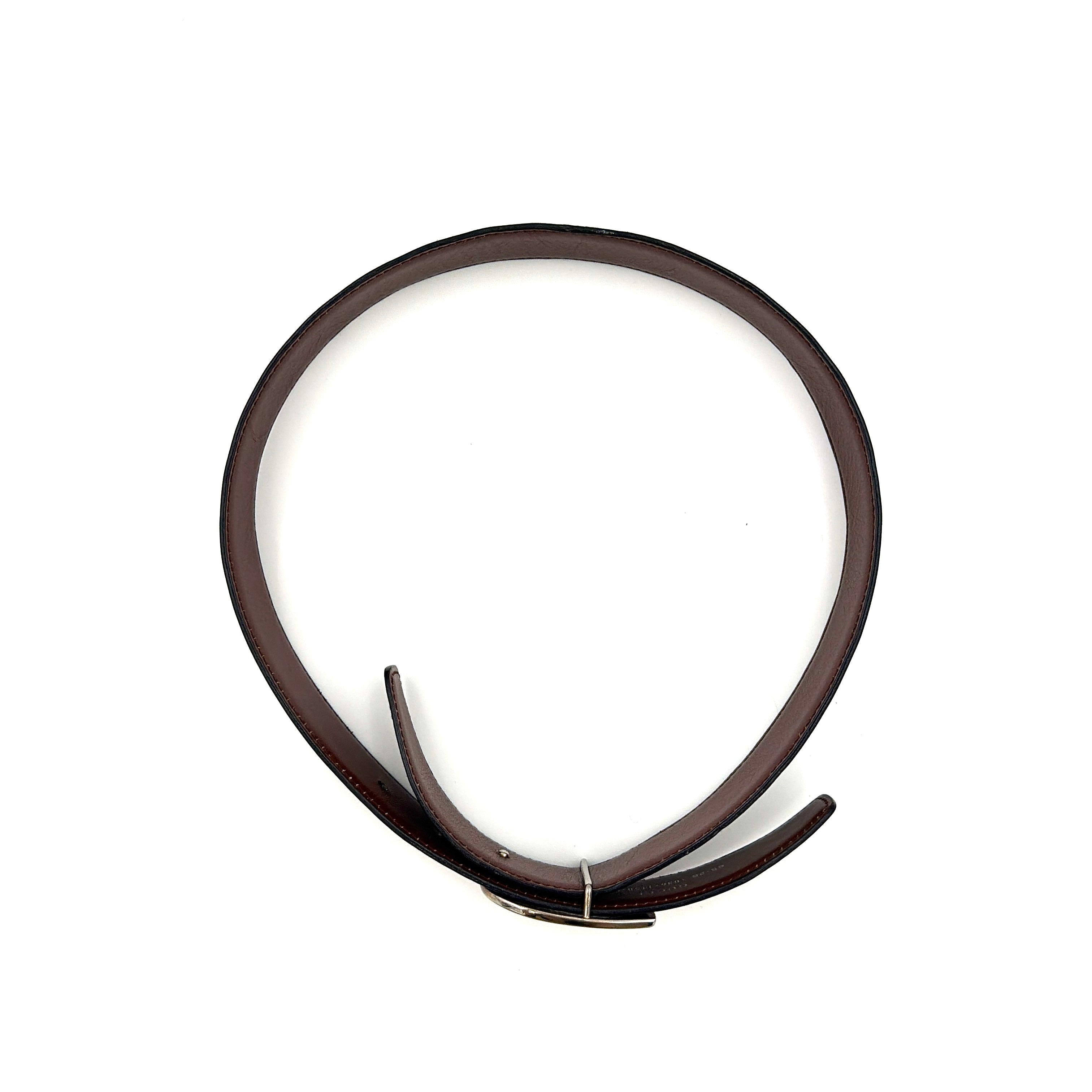 Gucci black leather belt with an oversized silver metal G logo buckle displayed in a curved profile.