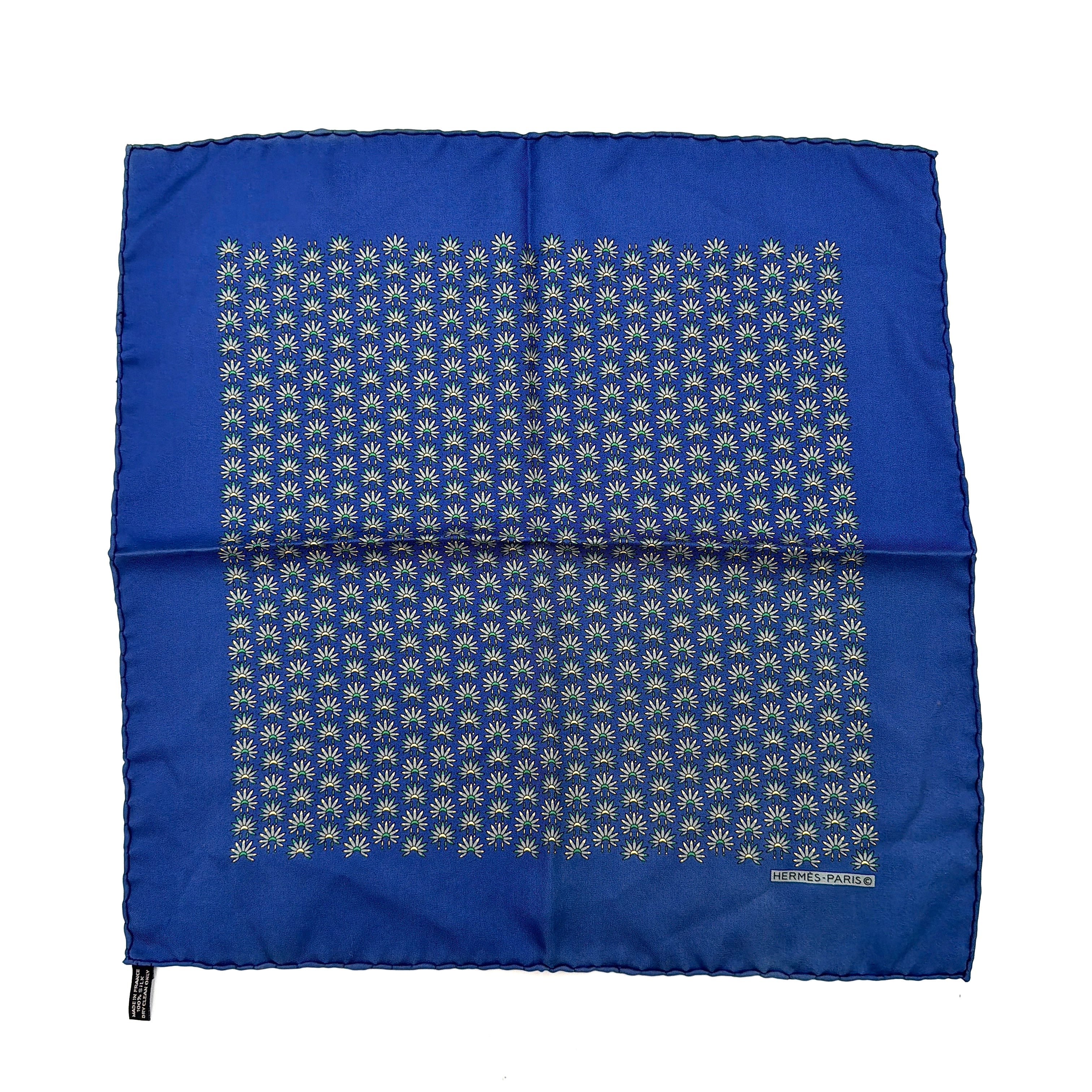 Hermès silk scarf in vibrant blue, featuring a precise all-over floral pattern and hand-rolled edges.