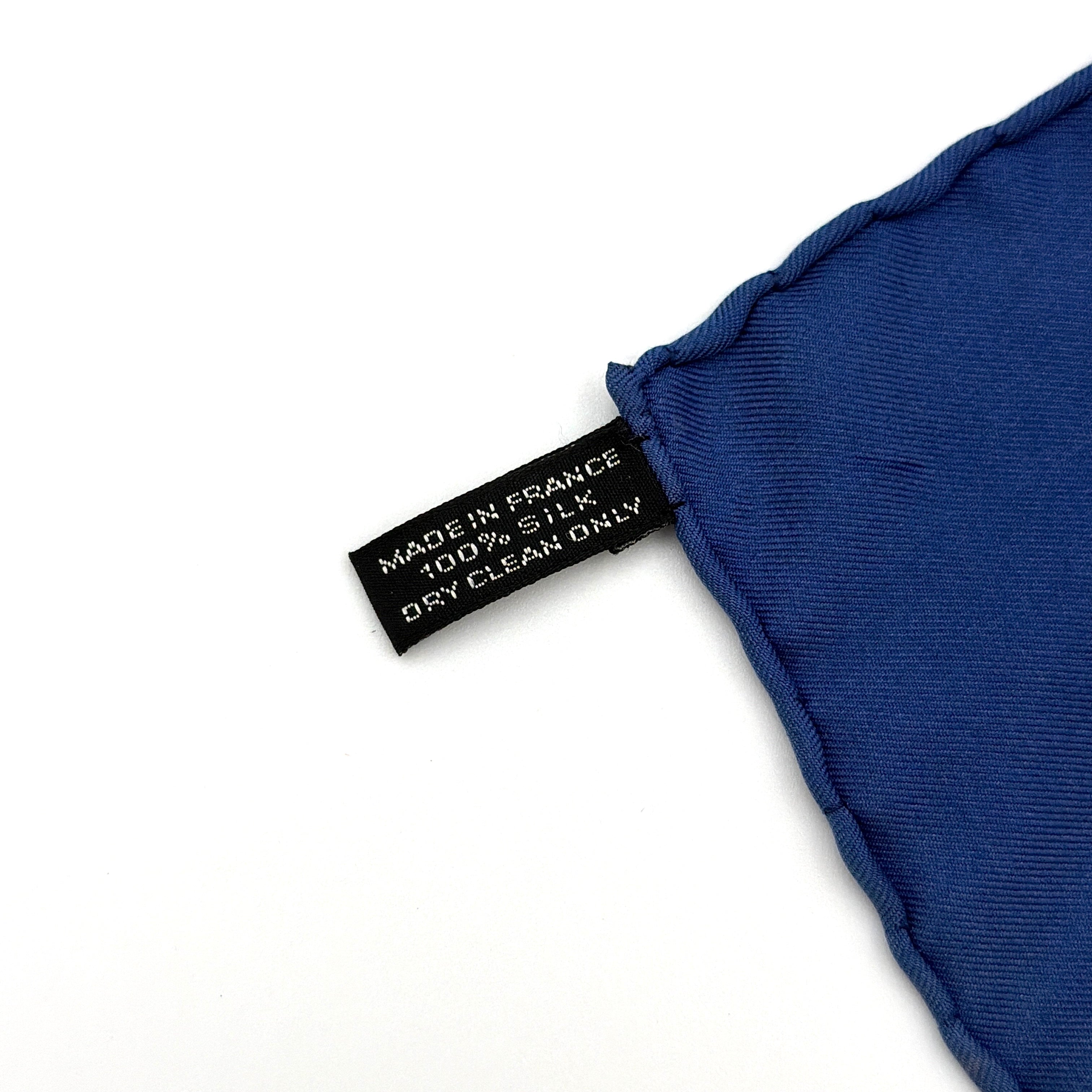 Hermès silk scarf in vibrant blue, featuring a precise all-over floral pattern and hand-rolled edges.