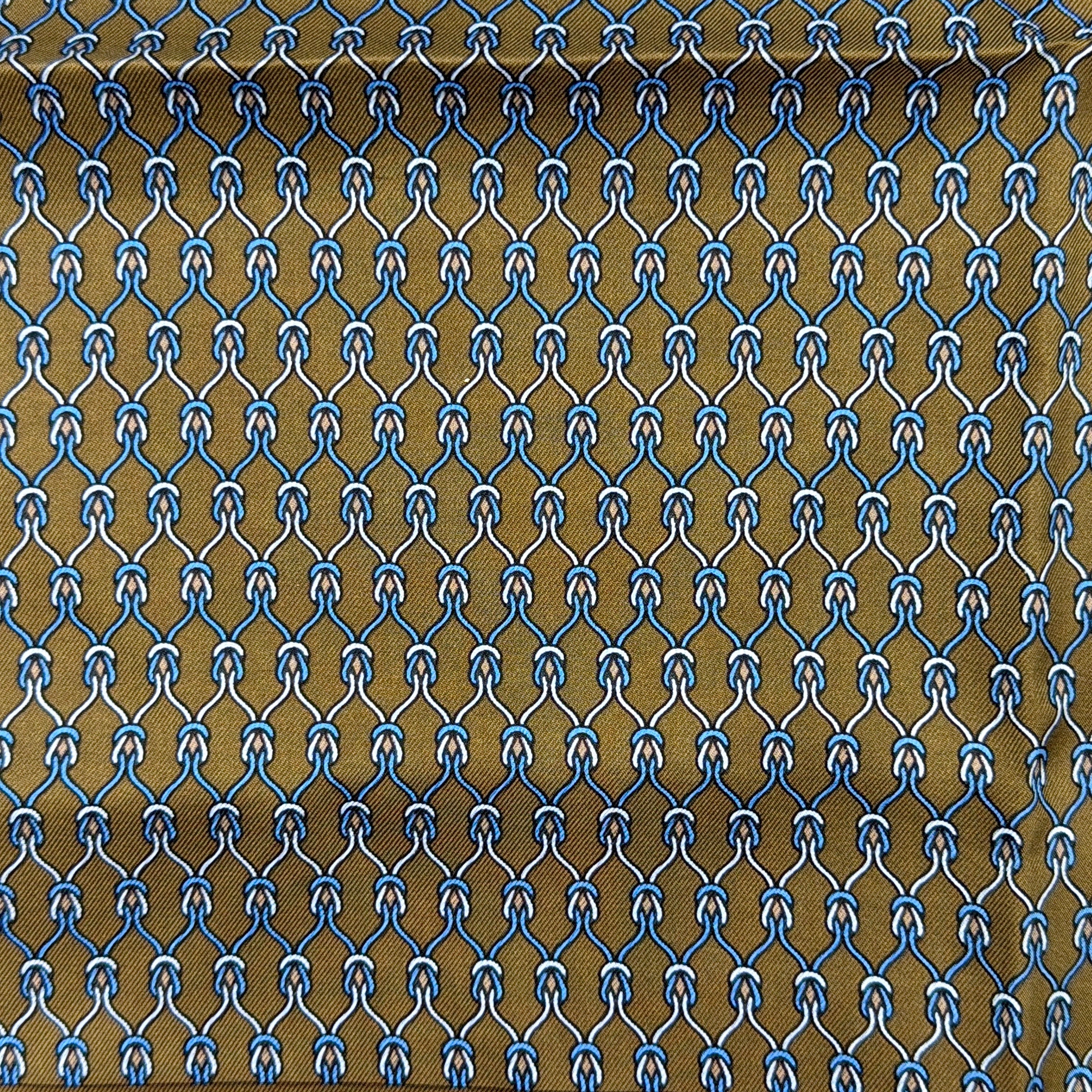 Hermès brown silk scarf featuring a blue and white chain link pattern, finished with elegant rolled edges.