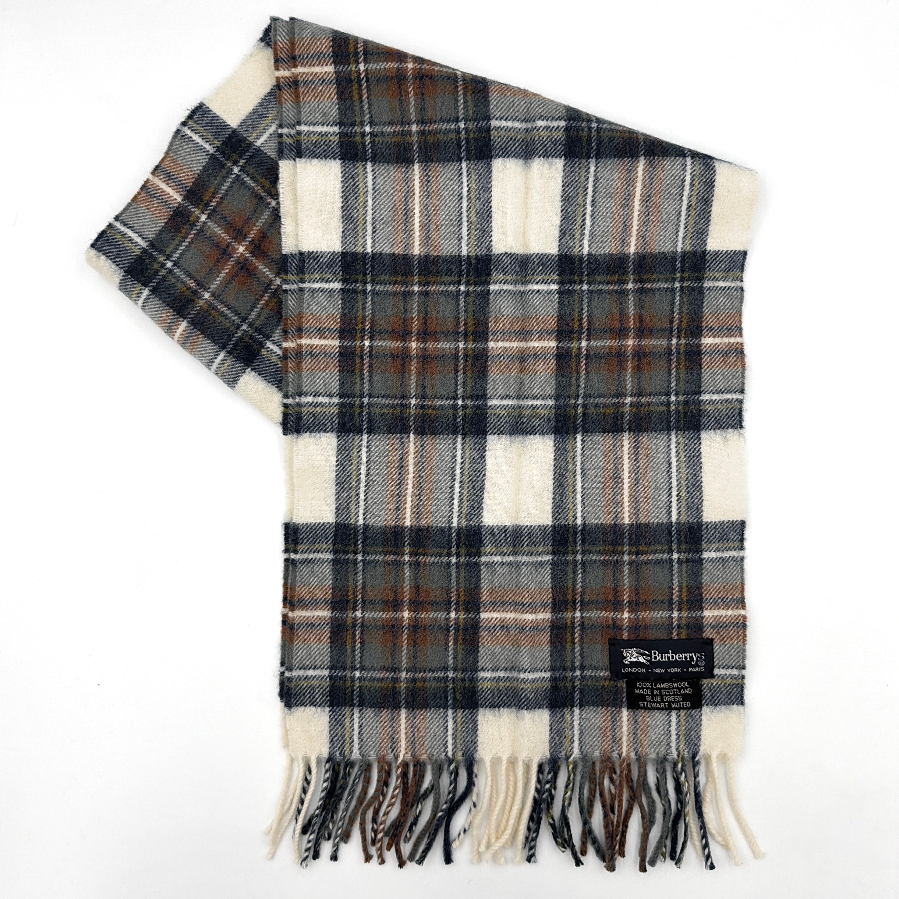 Burberry wool scarf in a muted blue, cream, and grey Stewart tartan, finished with long fringe and a woven heritage label.