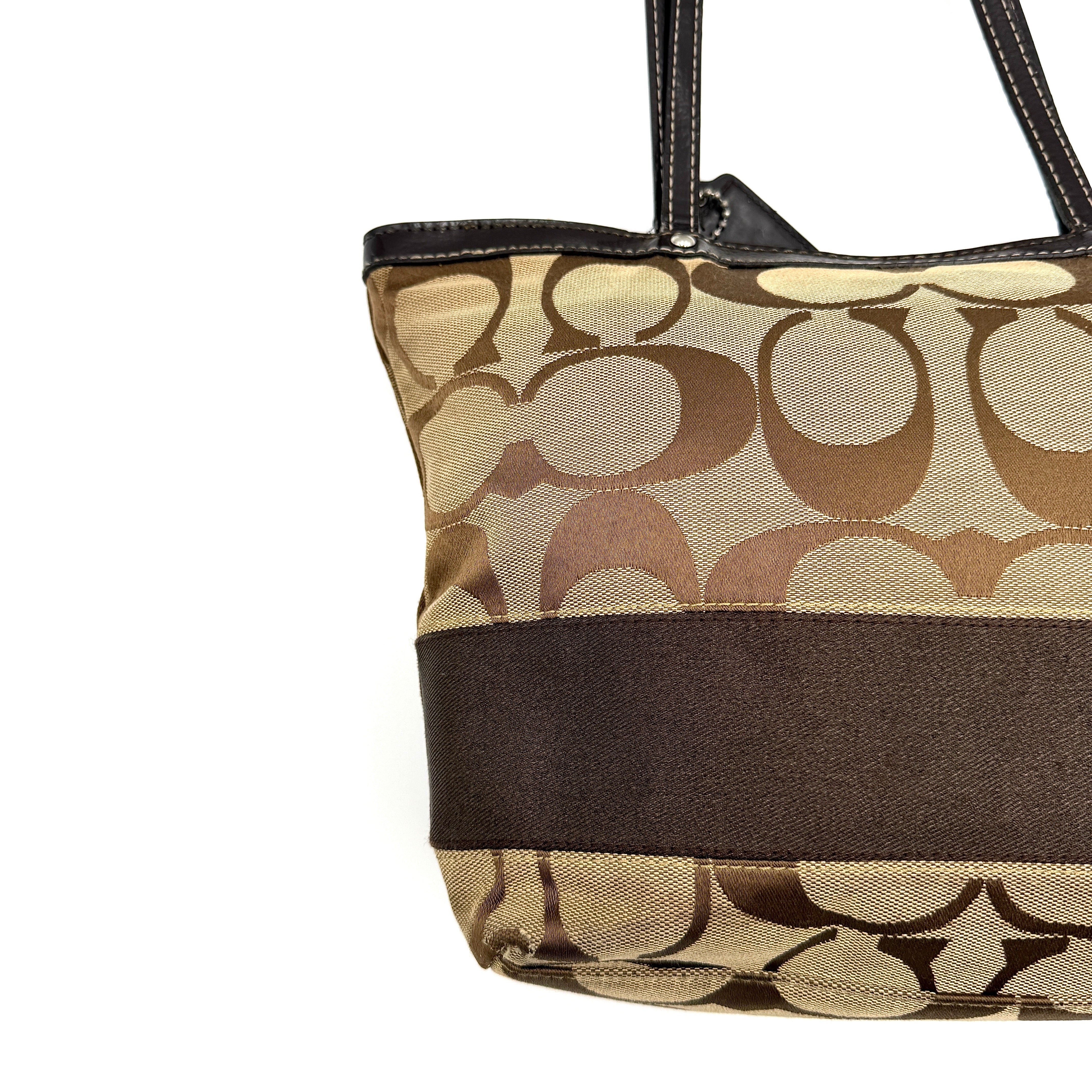 Coach Signature Stripe Tote Bag in beige and brown with bold monogram canvas, leather trim, and dual shoulder straps.