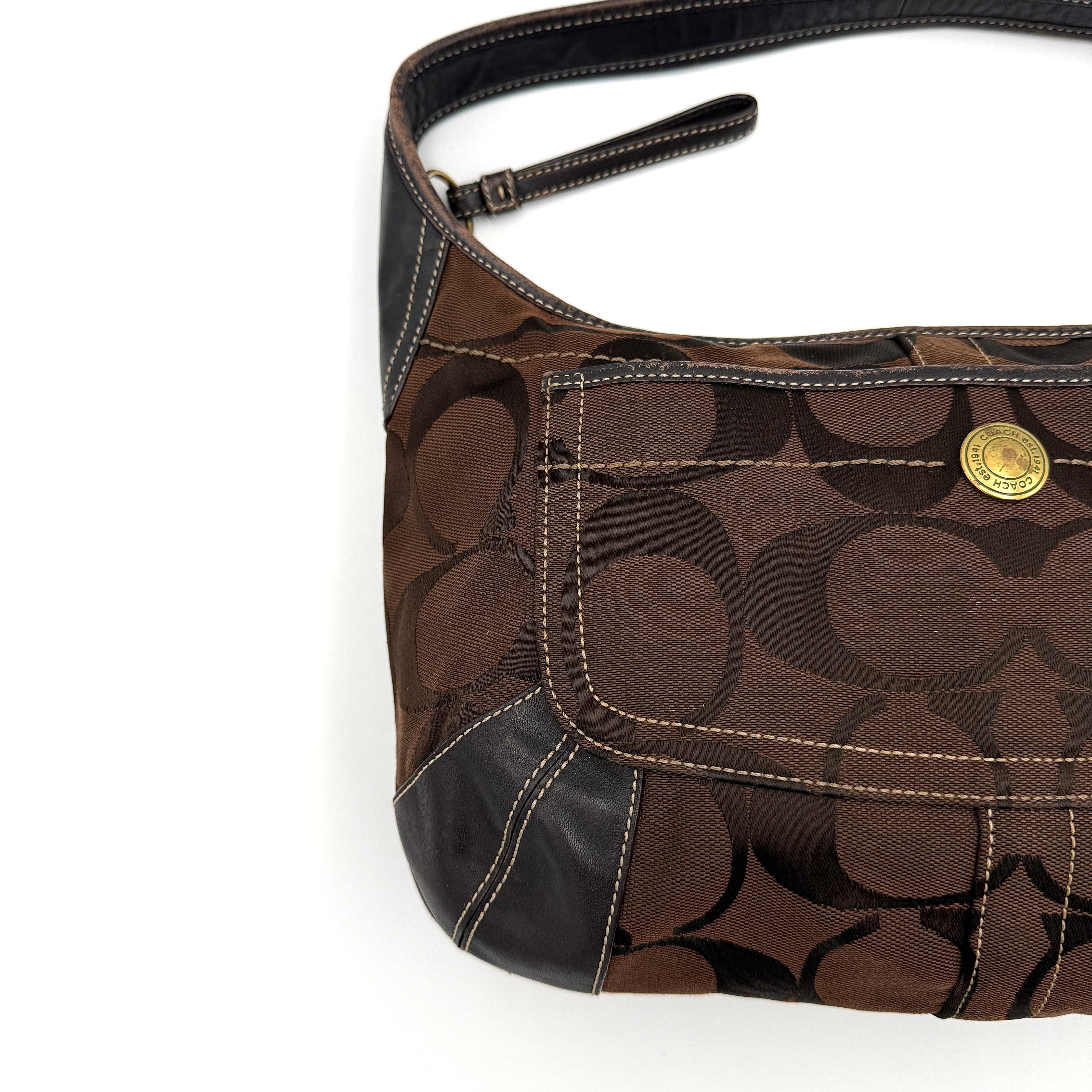 Coach Signature Ergo Hobo Shoulder Bag in brown monogram canvas with dark leather trim and gold-tone hardware, shown from the front.