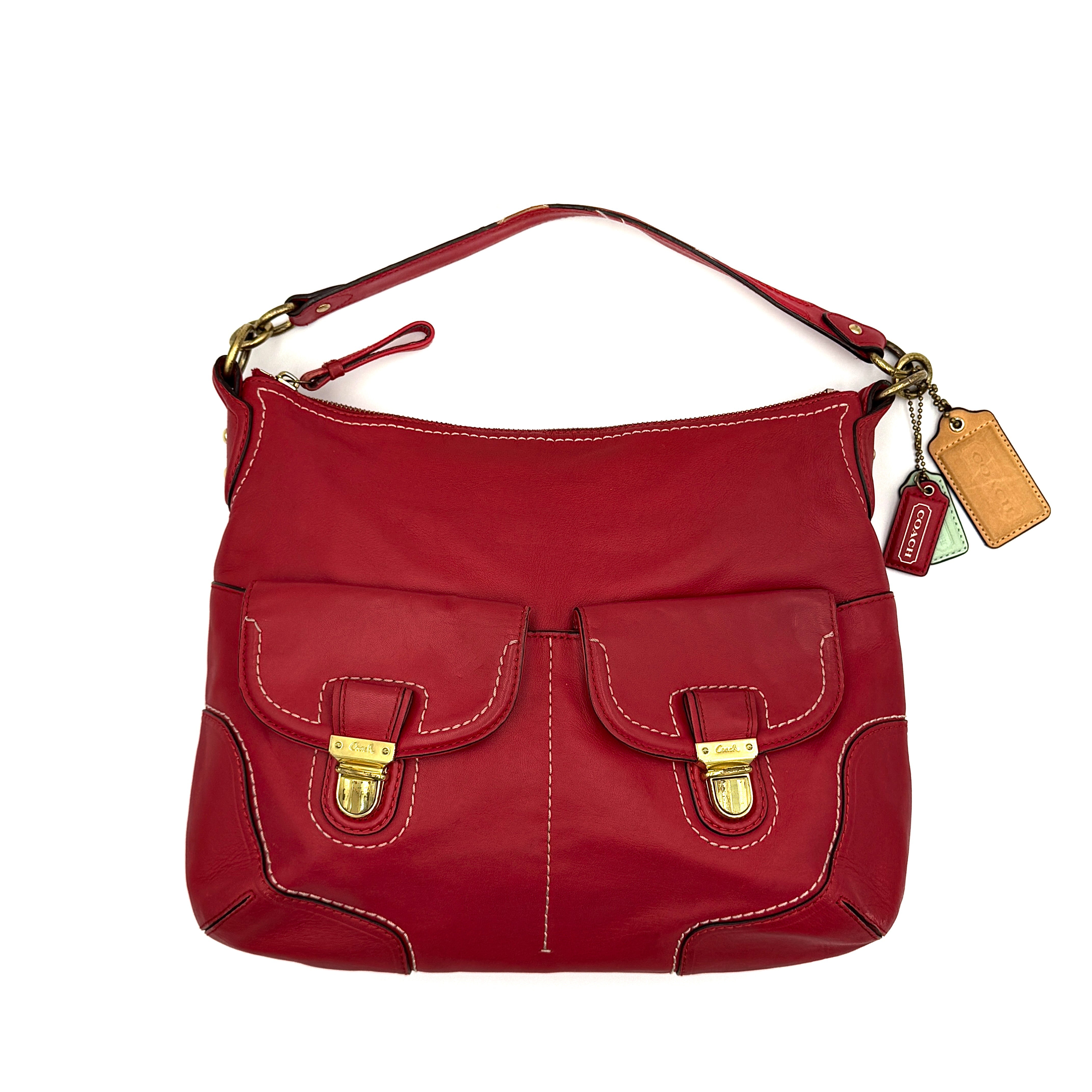 Coach Ashley Double Pocket Hobo in vibrant red leather, featuring distinctive front pockets, gold-tone hardware, and signature Coach hangtags.