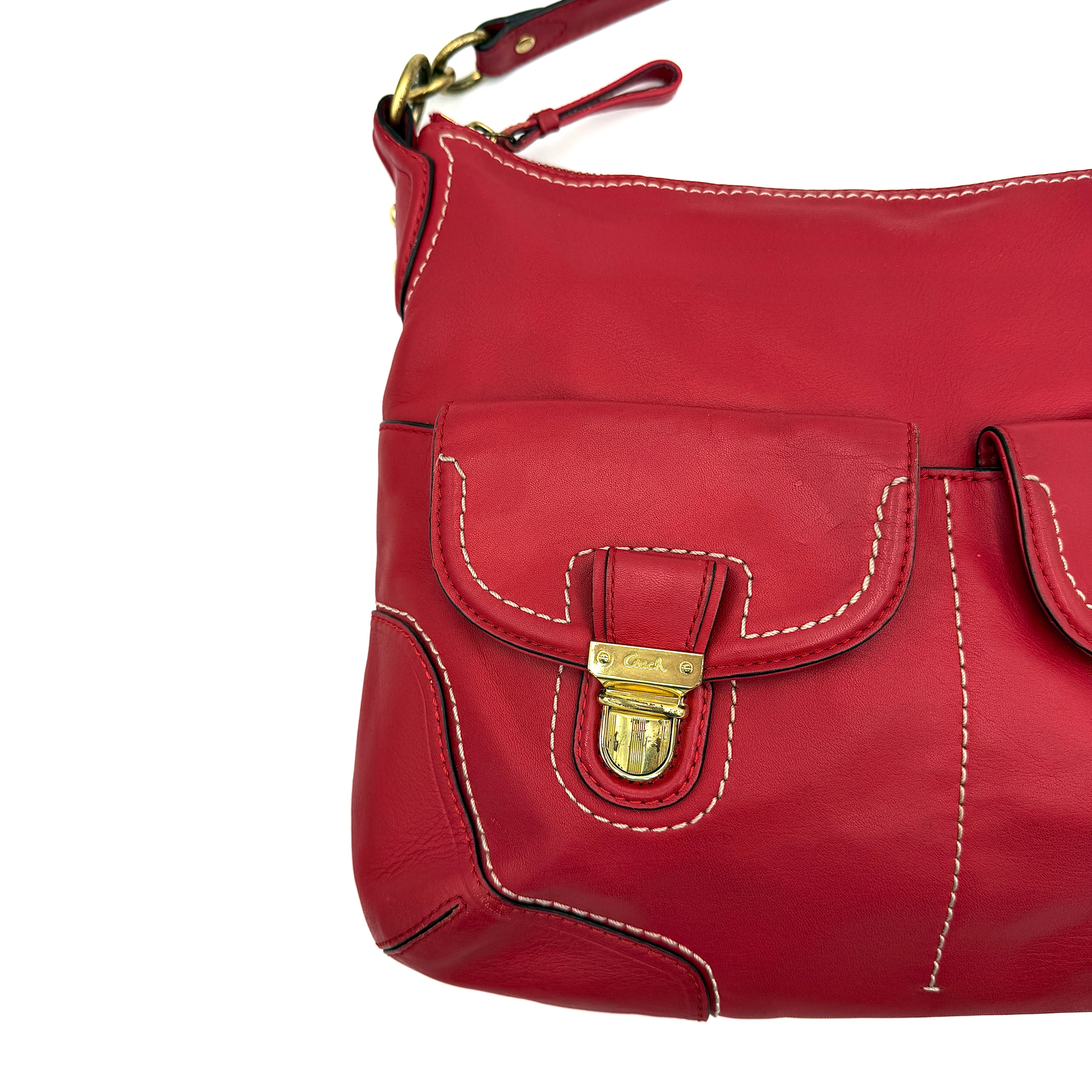 Coach Ashley Double Pocket Hobo in vibrant red leather, featuring distinctive front pockets, gold-tone hardware, and signature Coach hangtags.