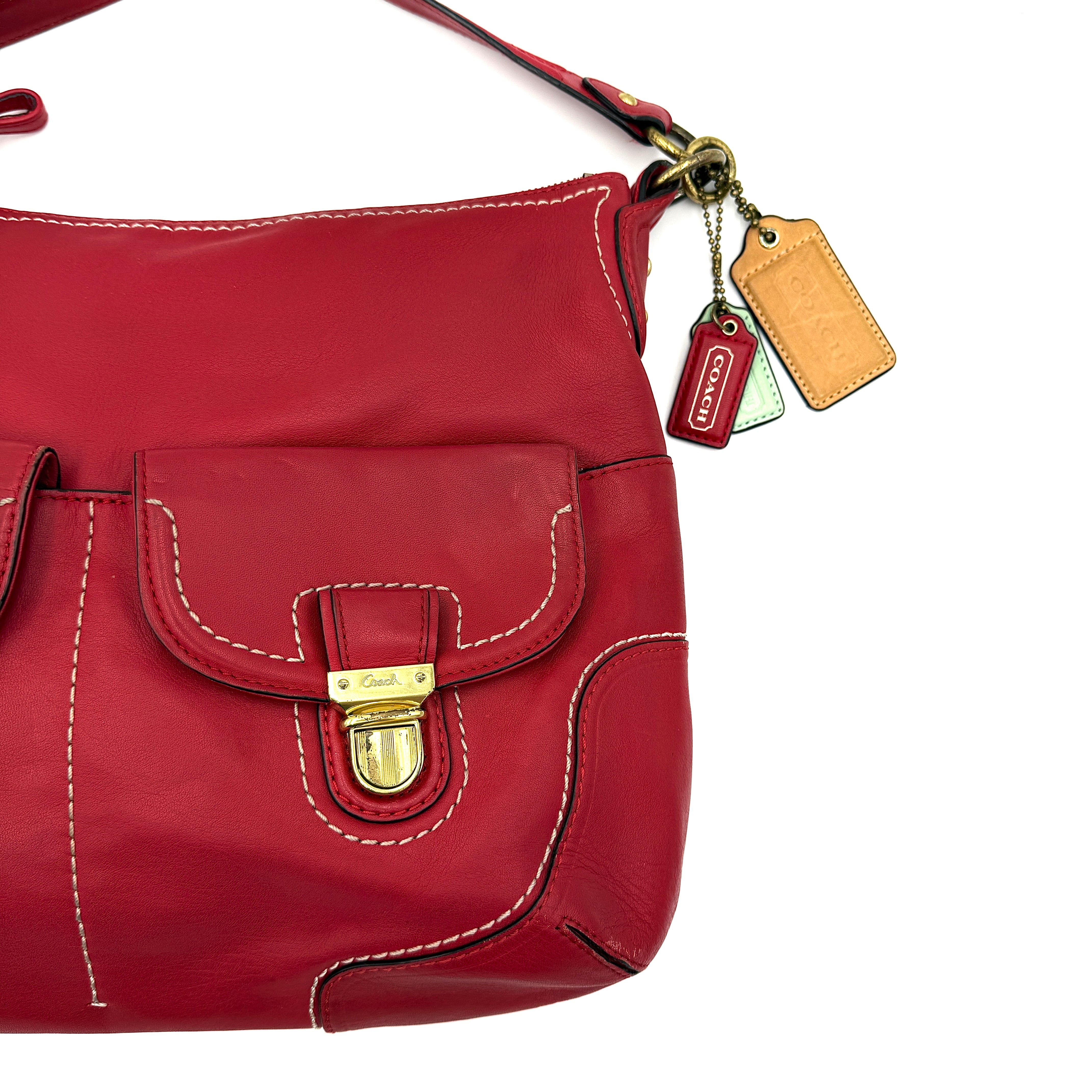 Coach Ashley Double Pocket Hobo in vibrant red leather, featuring distinctive front pockets, gold-tone hardware, and signature Coach hangtags.