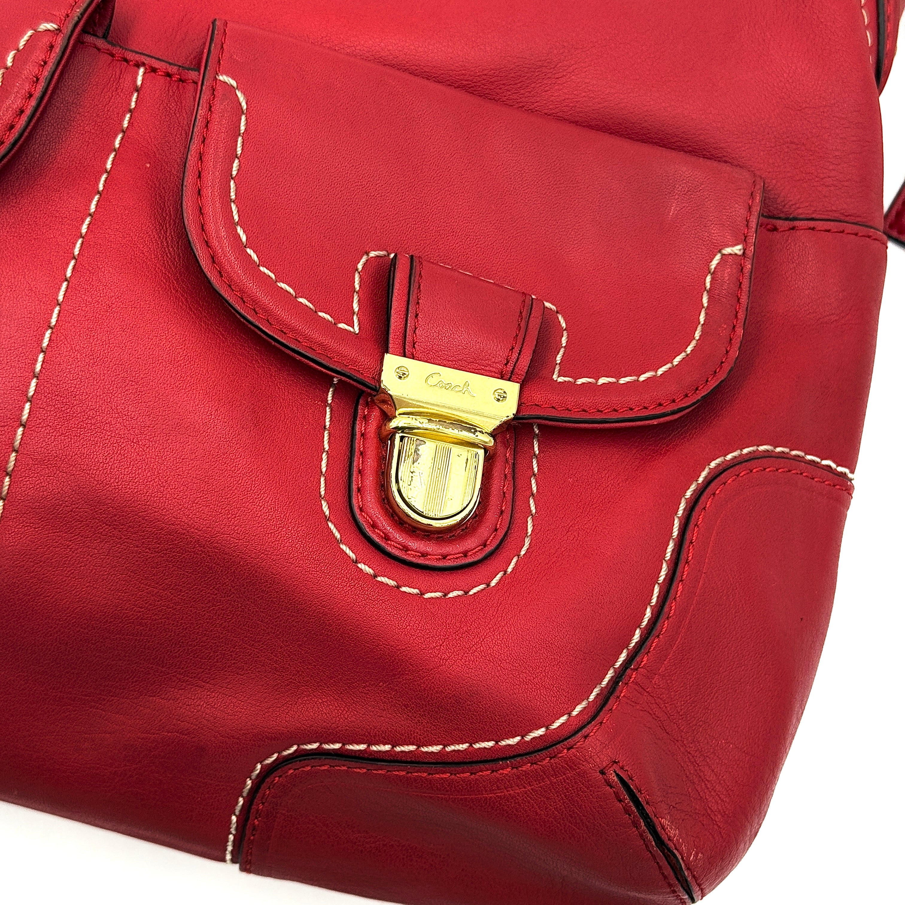 Coach Ashley Double Pocket Hobo in vibrant red leather, featuring distinctive front pockets, gold-tone hardware, and signature Coach hangtags.