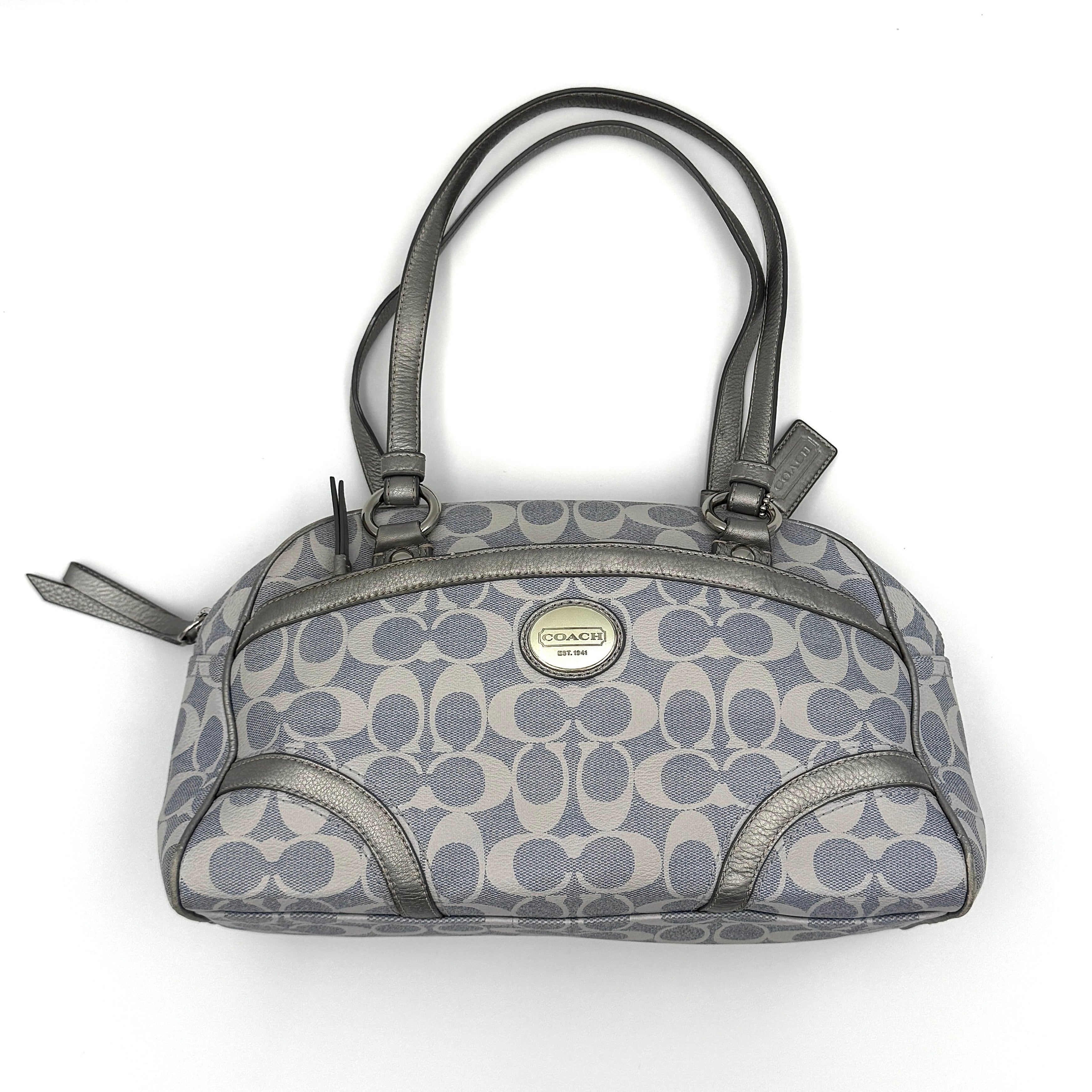 Coach Signature Peyton Satchel in light blue and grey canvas with metallic leather trim and double handles, shown against a white background.