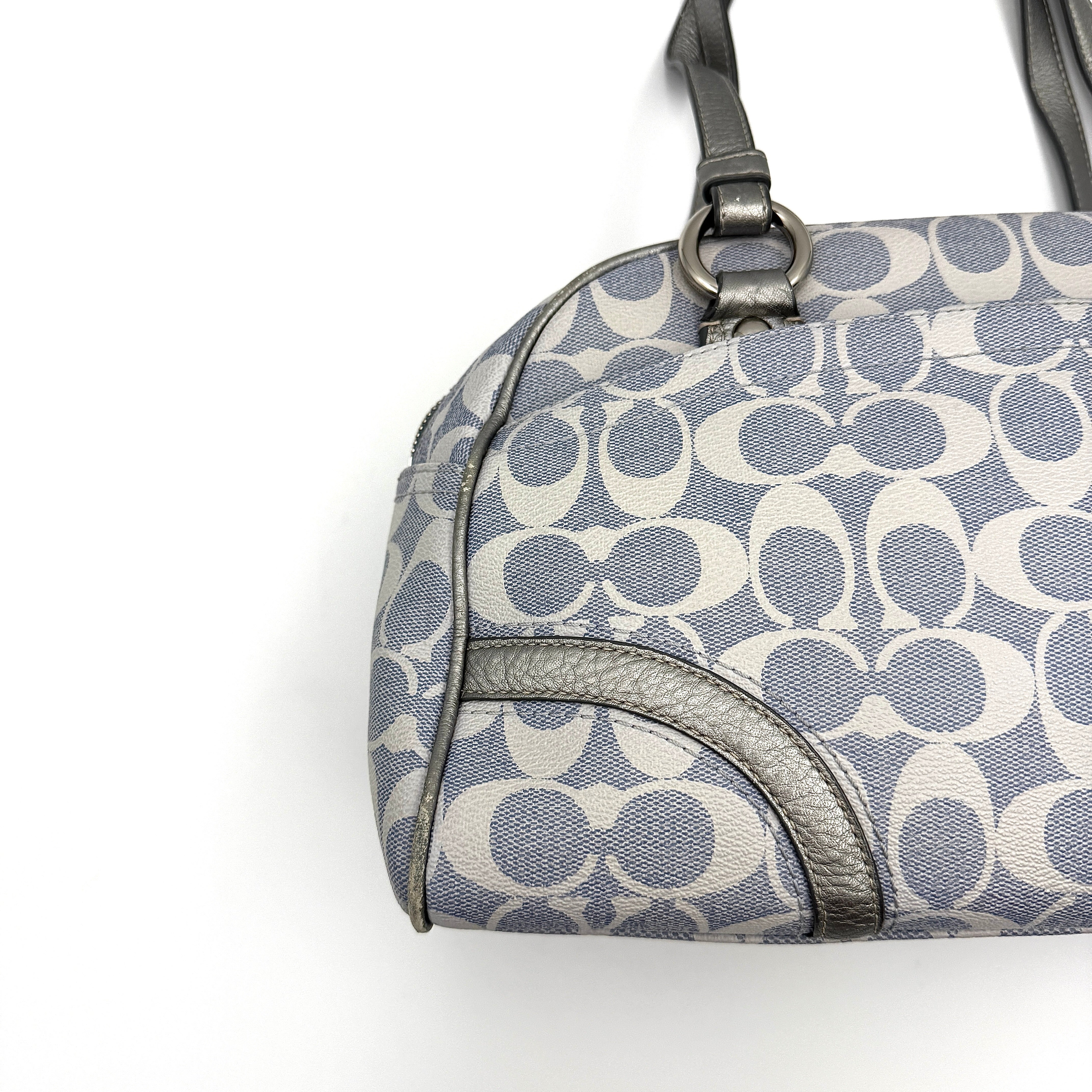 Coach Signature Peyton Satchel in light blue and grey canvas with metallic leather trim and double handles, shown against a white background.