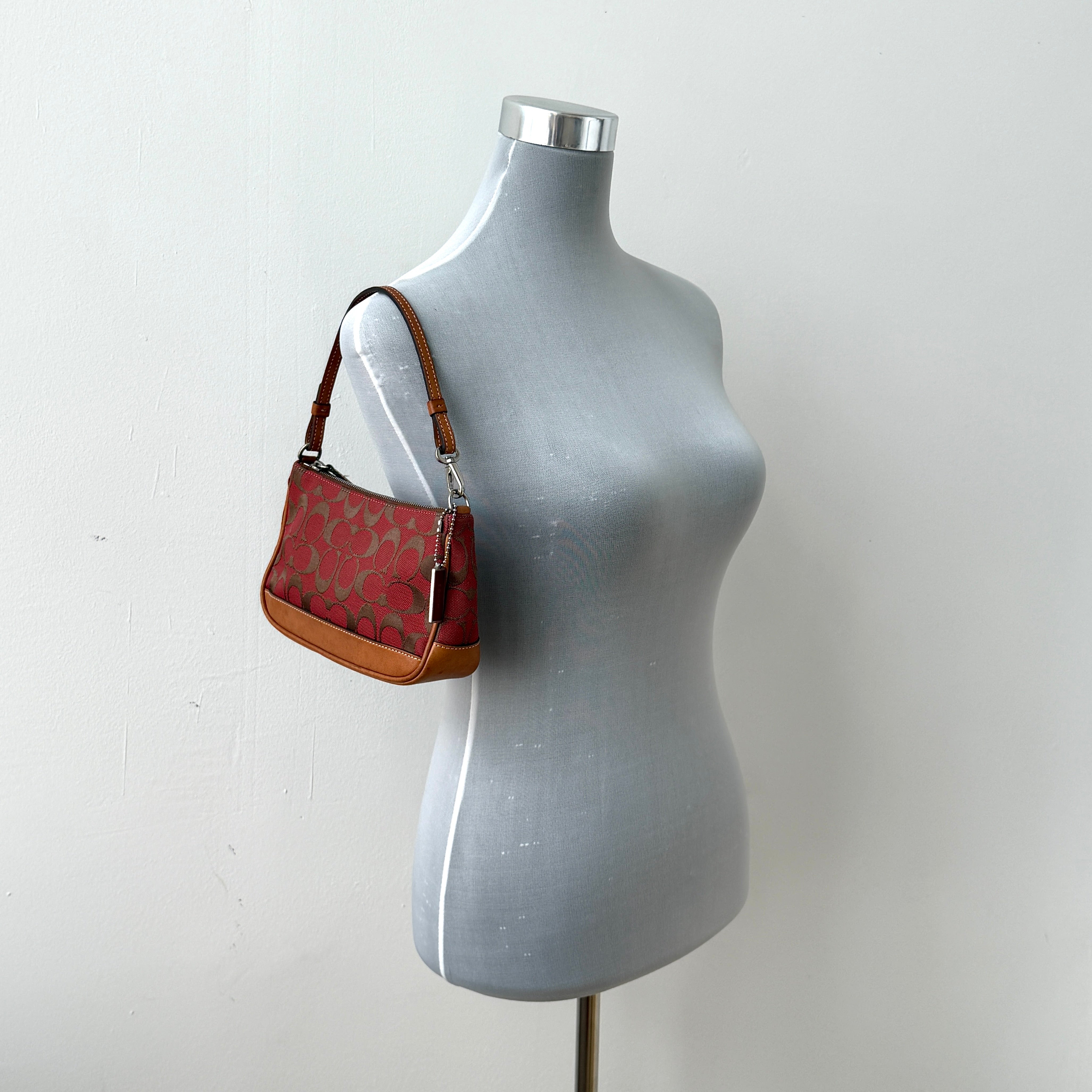 Coach Y2K Demi Shoulder Bag in red jacquard canvas with tan leather trim and silver-tone hardware, featuring a signature enamel Coach hangtag.