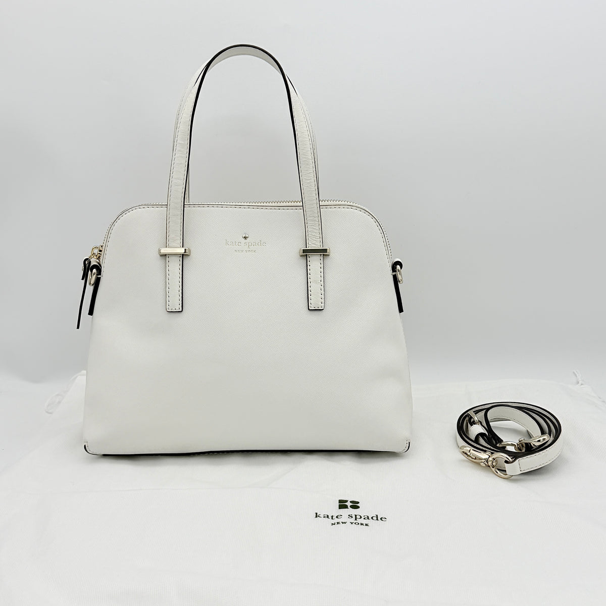 Top view of the Kate Spade Cedar Street Maise satchel in ivory, showing its spacious polka dot interior and zip pocket detail.